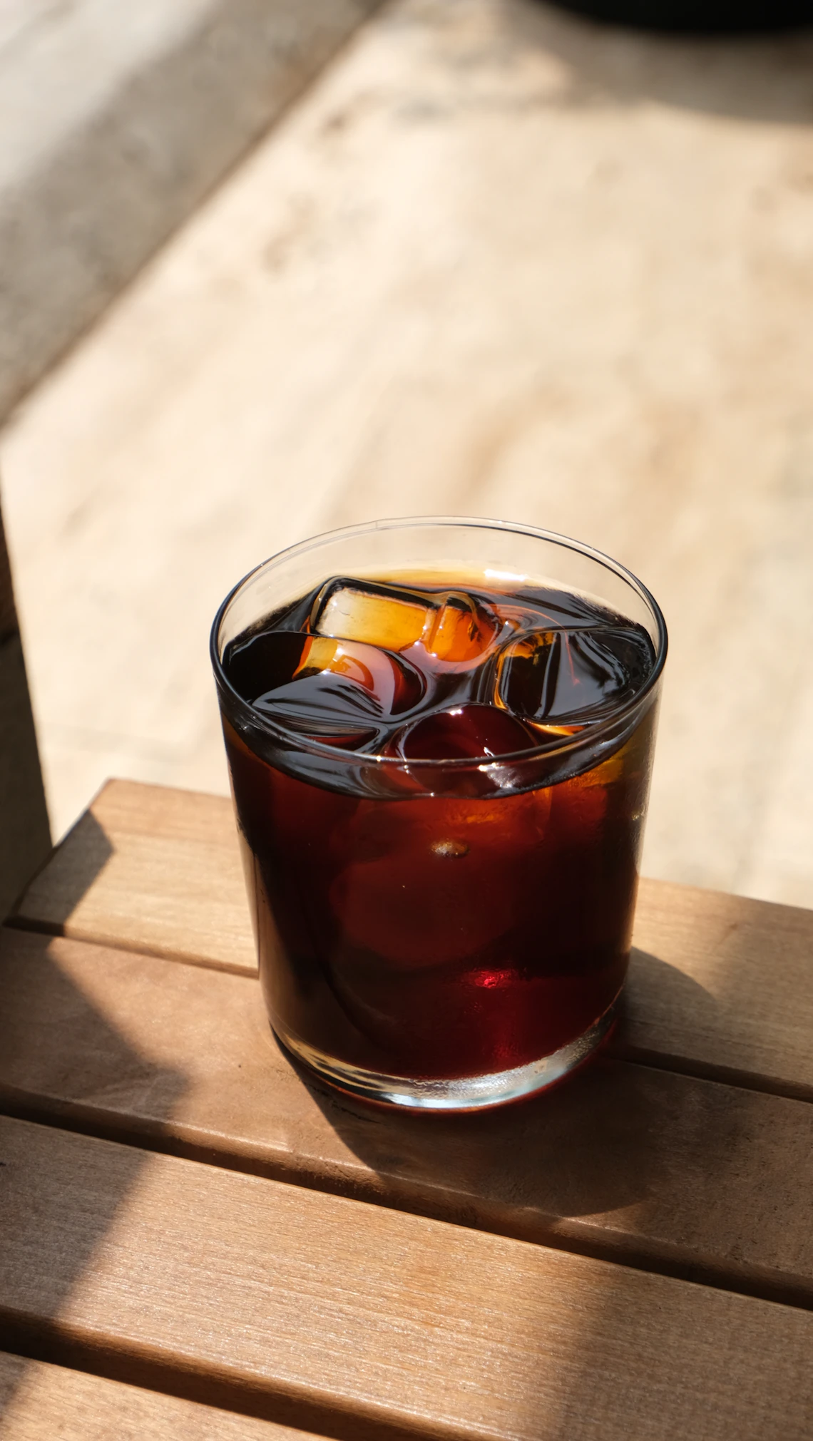 Cold coffee in a glass on a wooden table