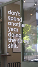 The sign encourages breaking routine and change.