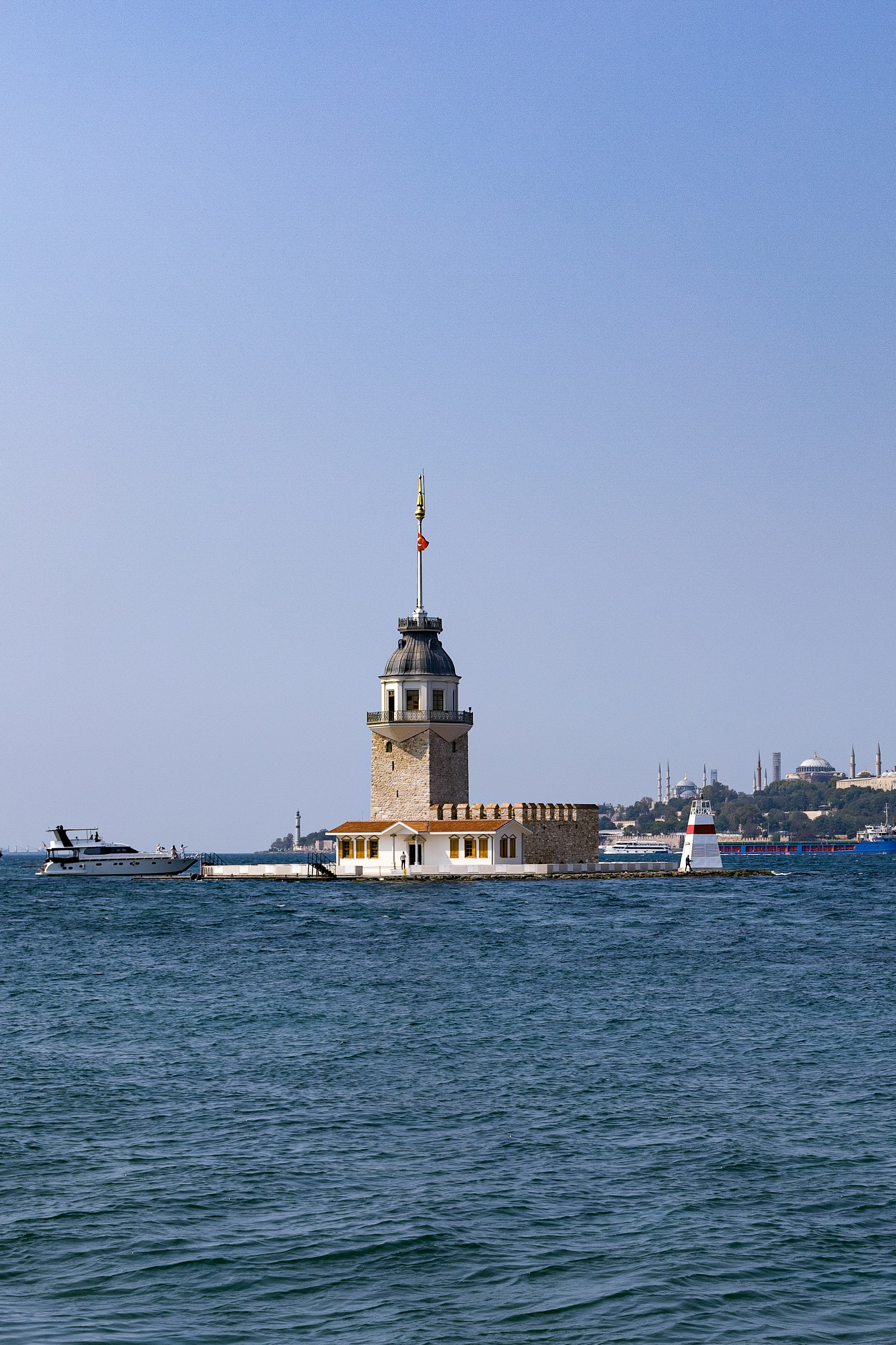 The maiden's tower stands in the turquoise sea.