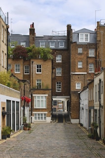 A cobblestone street leads into buildings.