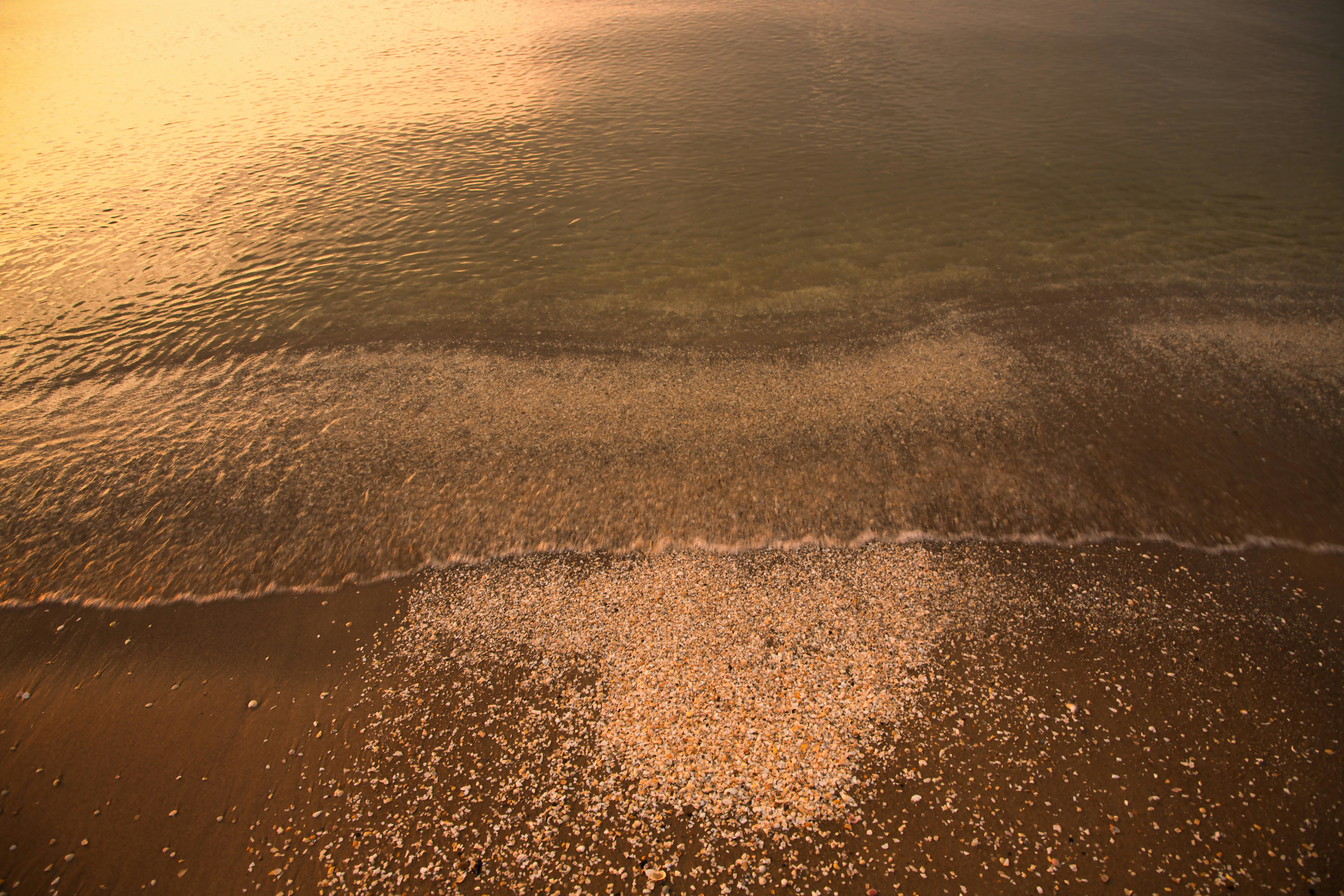 Gentle waves kissing the sandy beach.