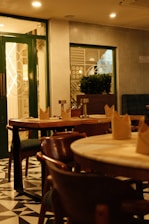 A cozy restaurant interior with wooden tables and chairs.