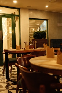 A cozy restaurant interior with wooden tables and chairs.