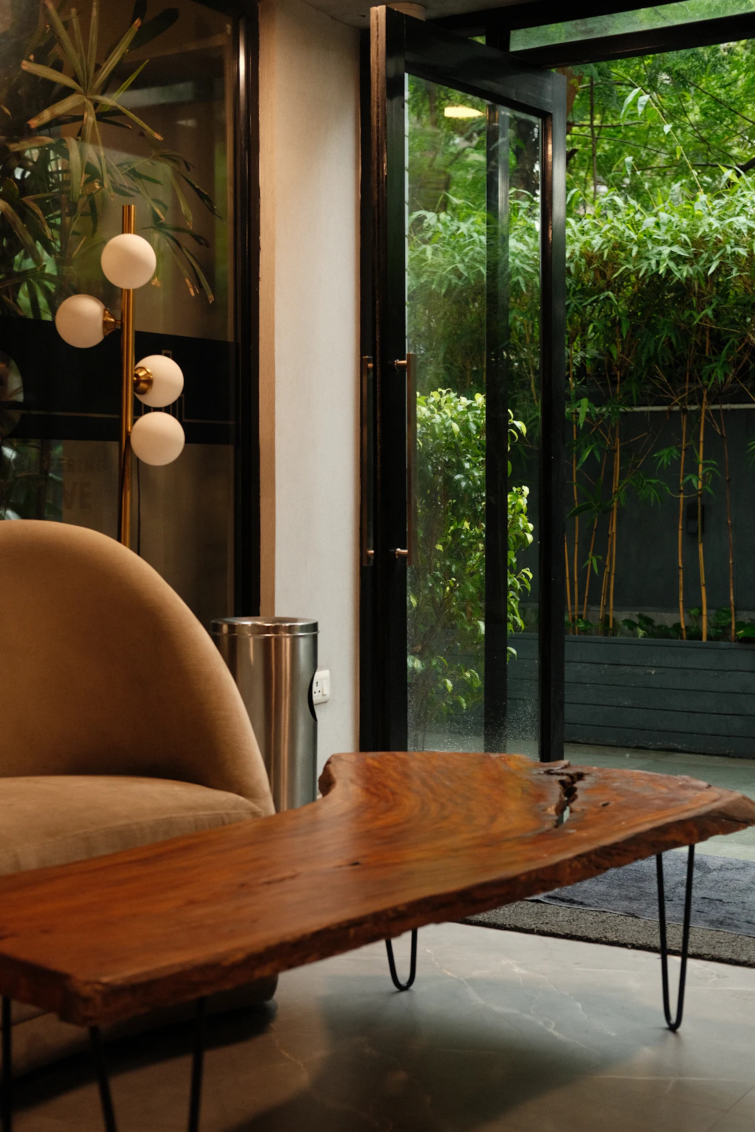 A quiet, warmly lit sitting room with a wooden table and soft daylight