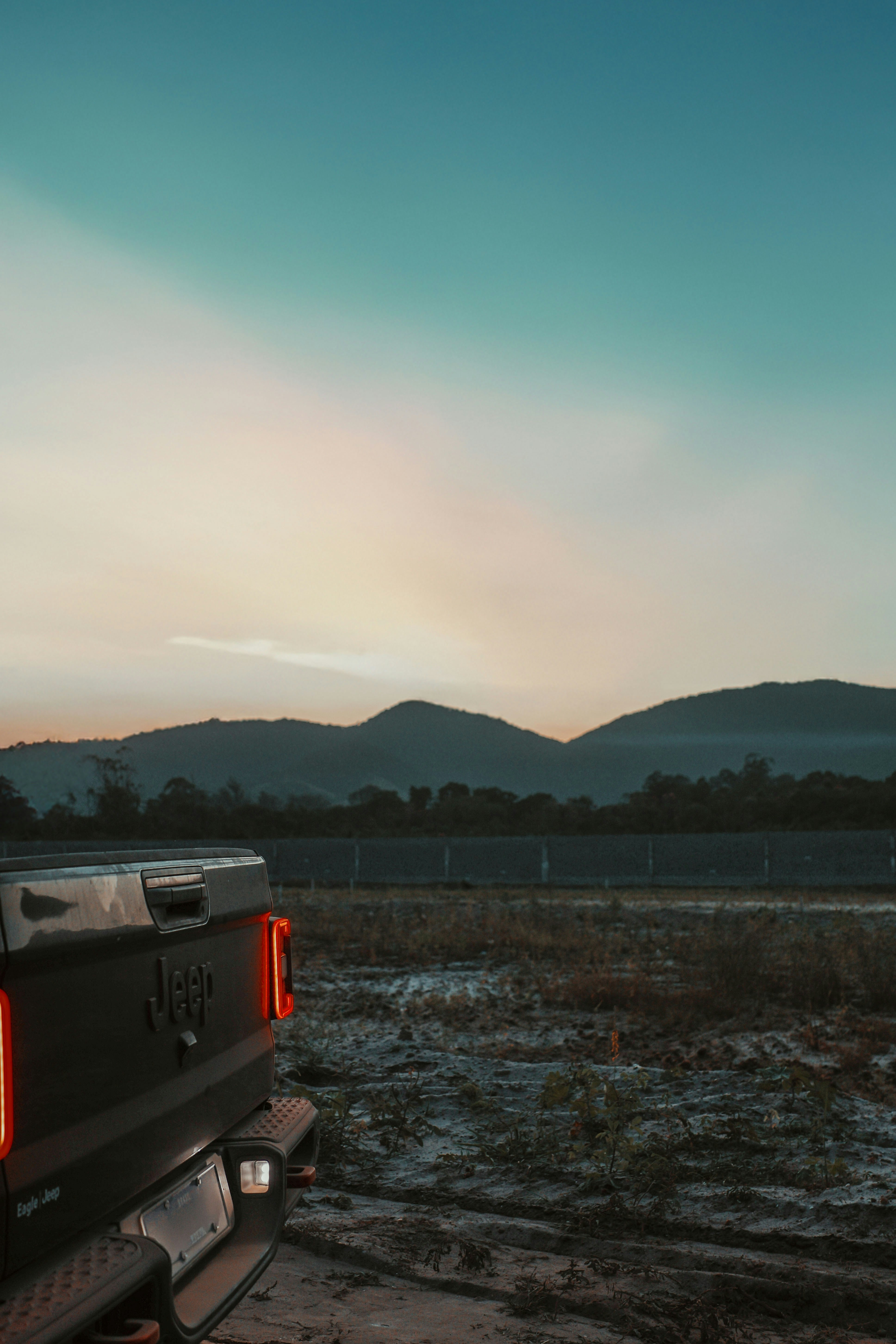 A jeep truck parked with a scenic mountain view