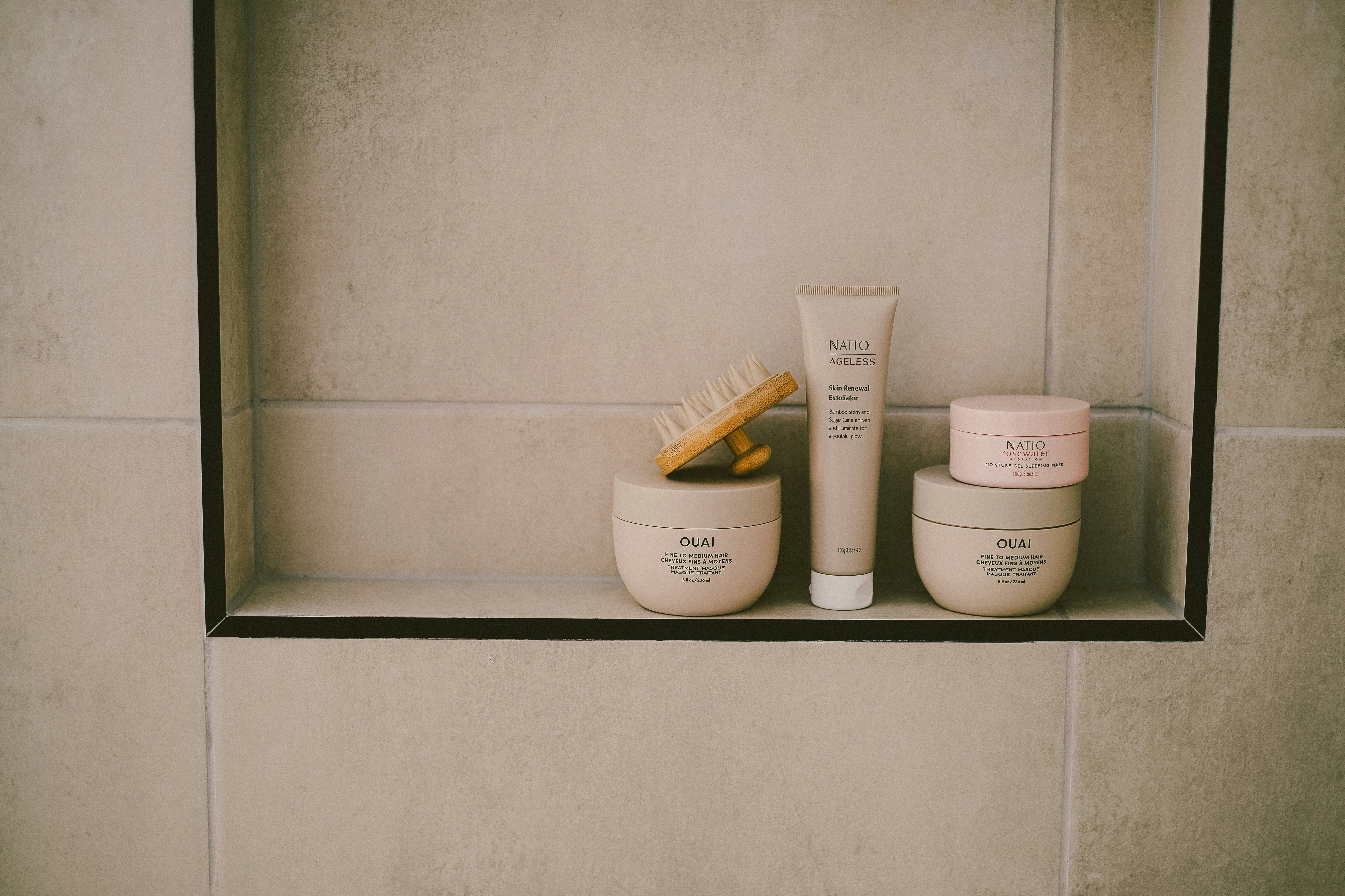Cosmetics are neatly arranged in a tiled shelf.