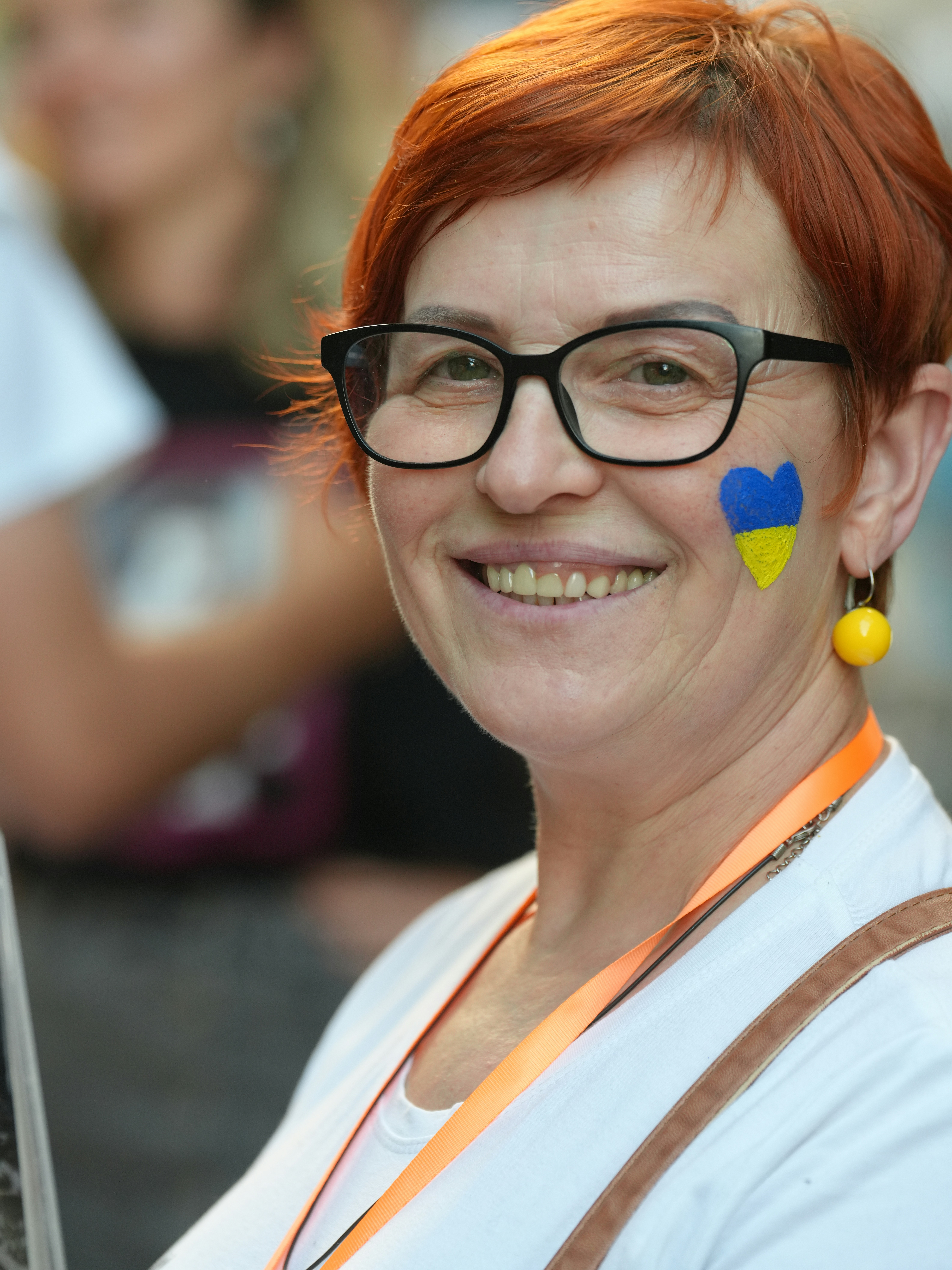 A woman shows ukrainian pride with a smile.