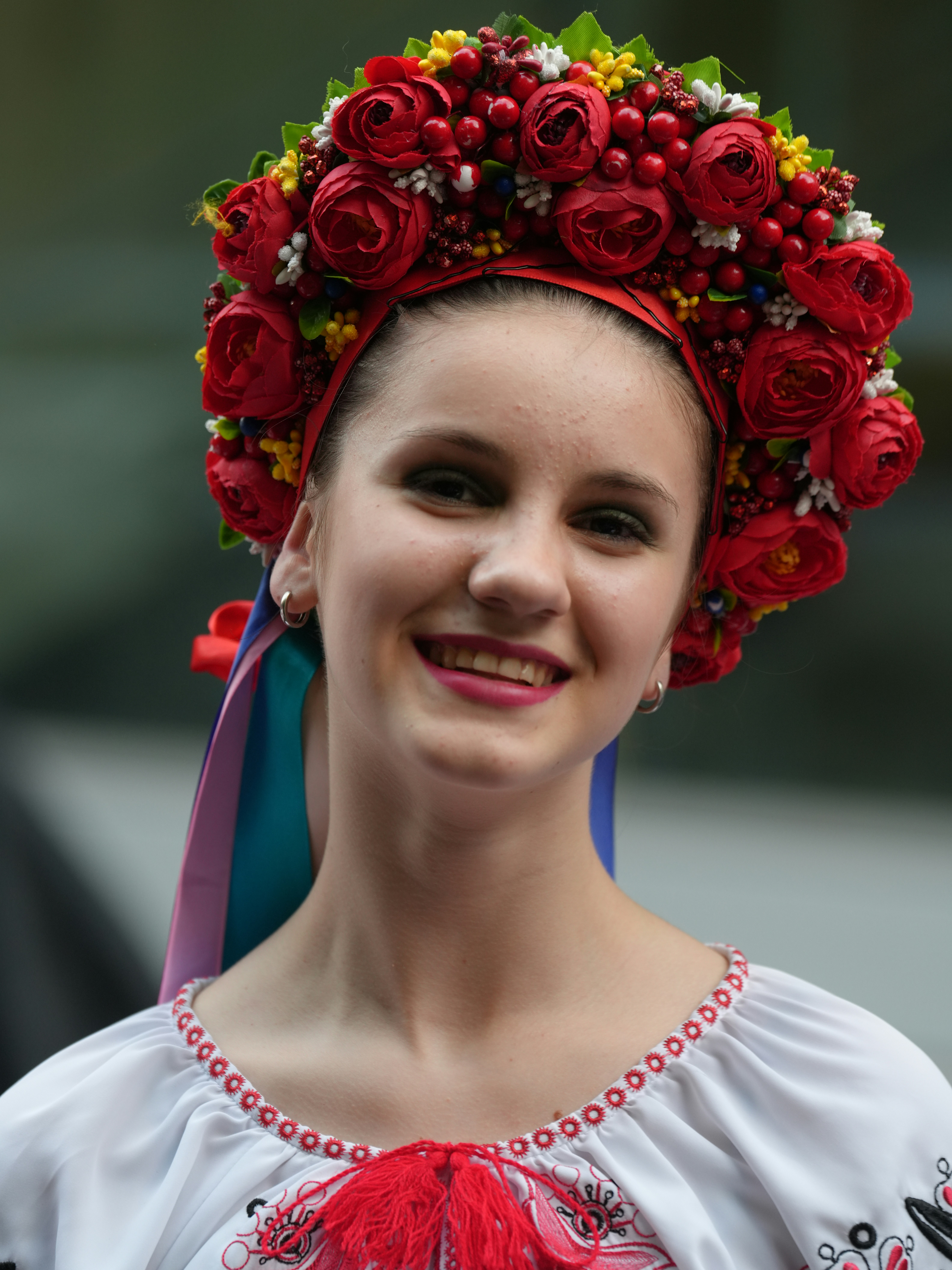 Smiling woman wearing a floral ukrainian headdress.