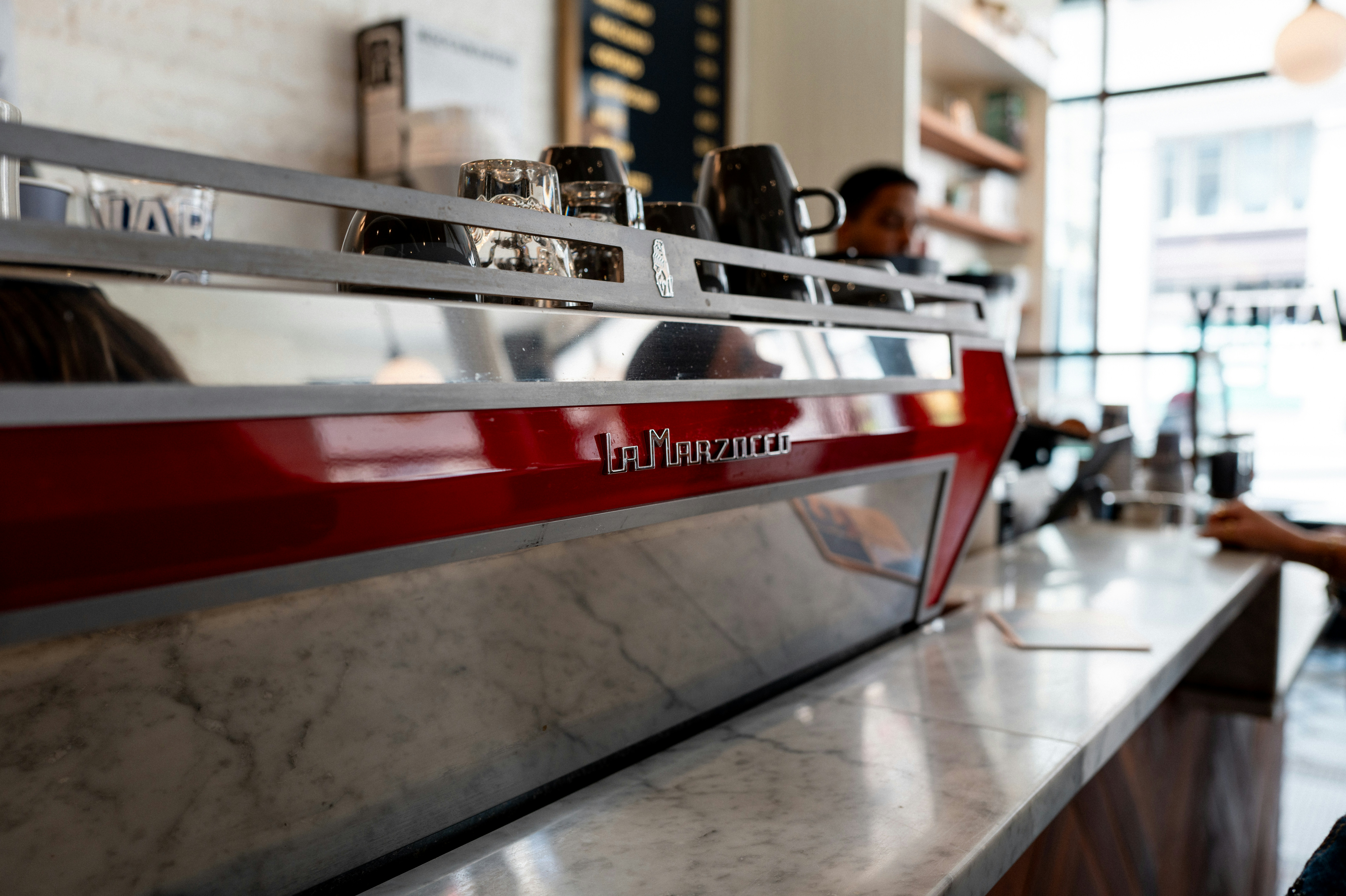 A coffee machine at a restaurant counter.