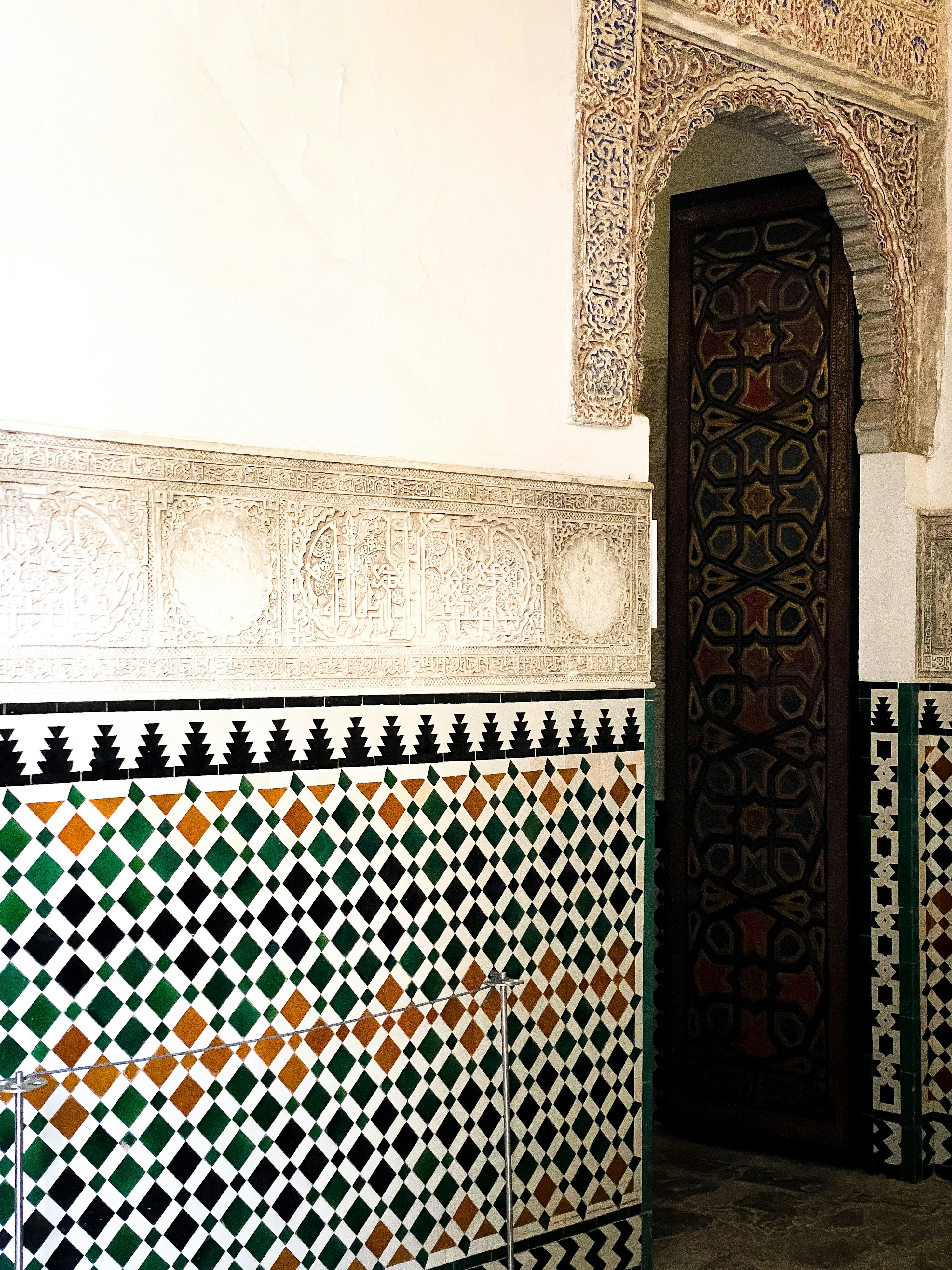 Ornate doorway and tilework inside a building.