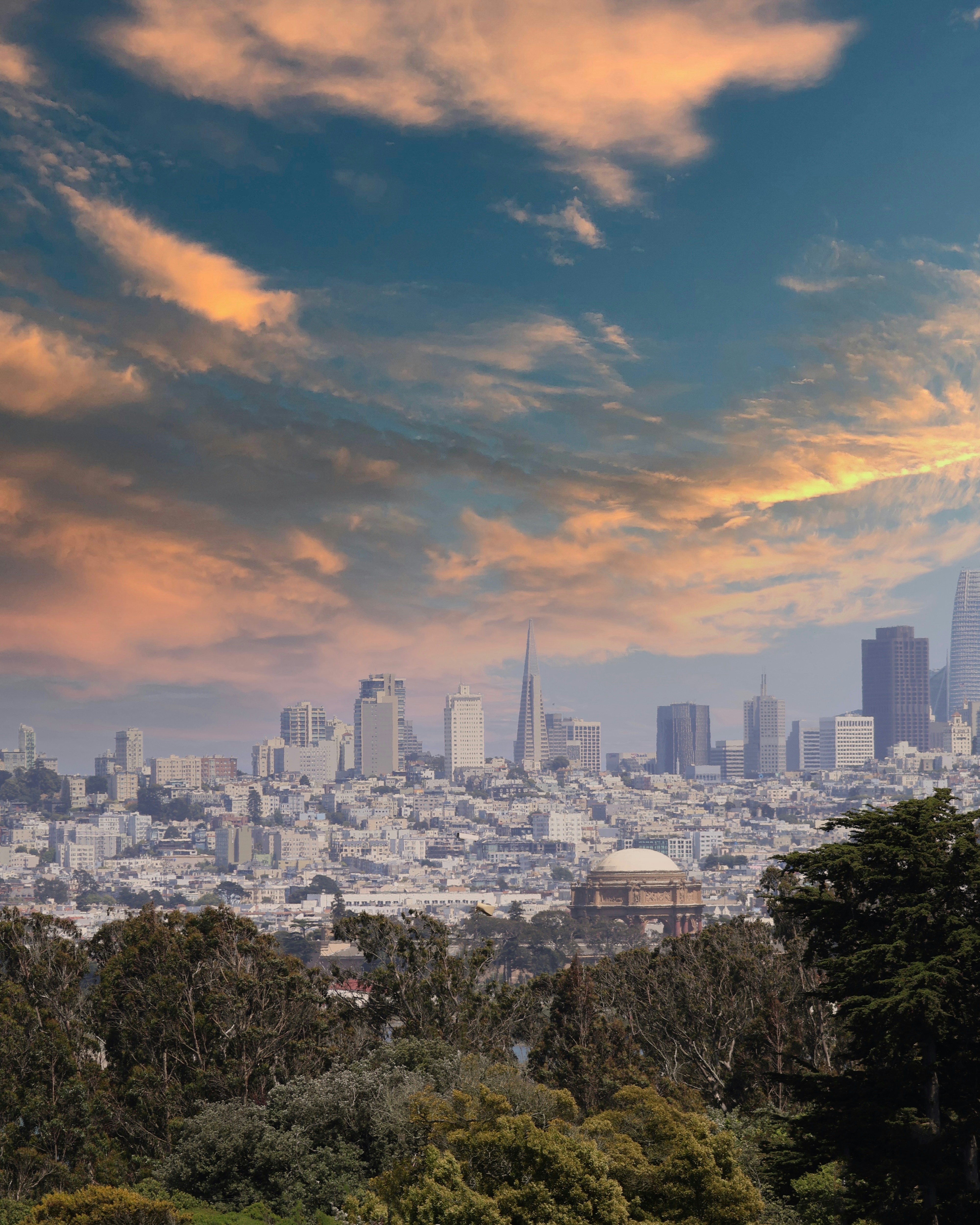 San francisco skyline framed by sunset clouds.