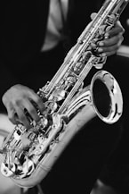 A person plays a saxophone.