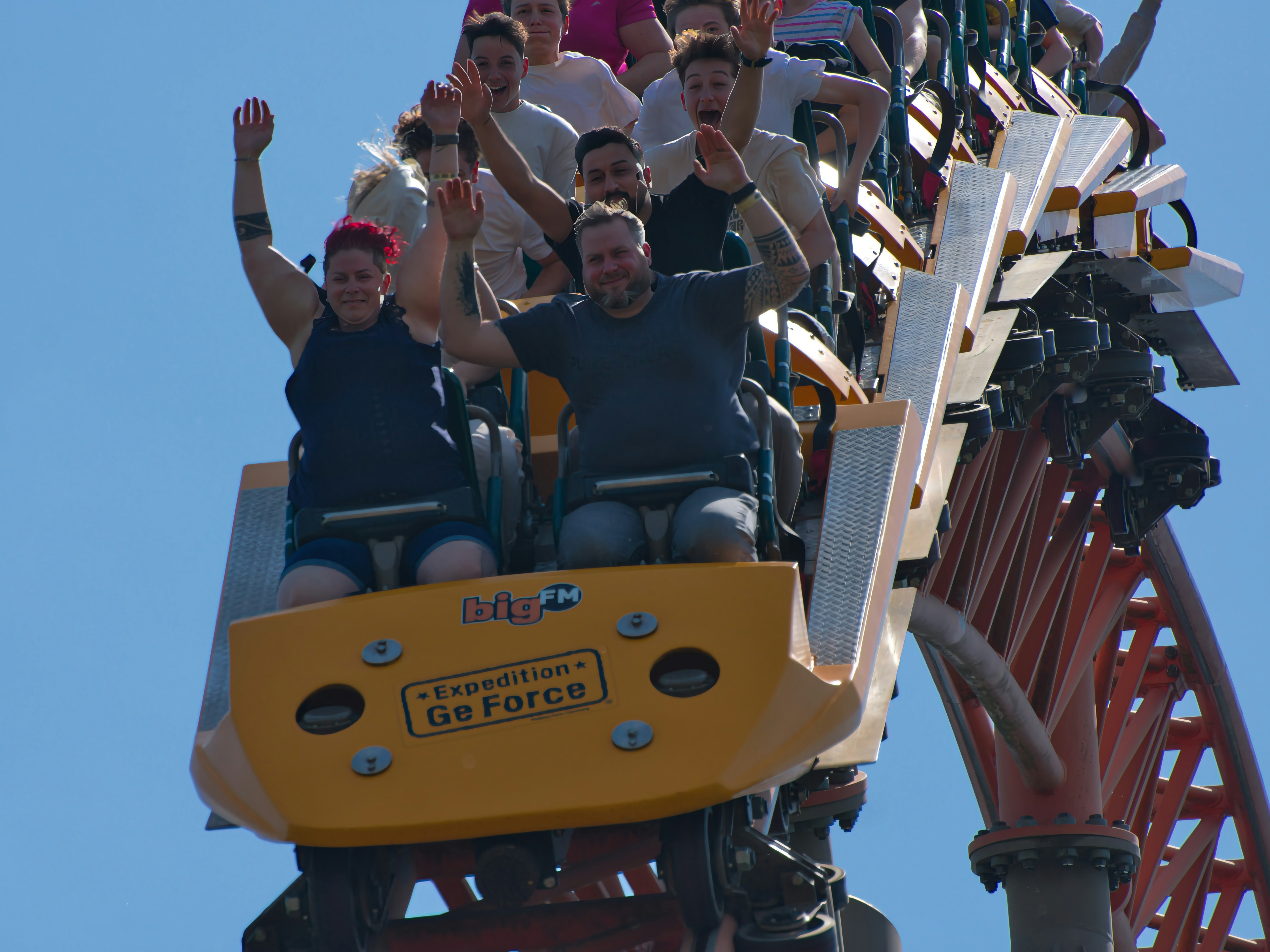 People are screaming with joy on a rollercoaster.