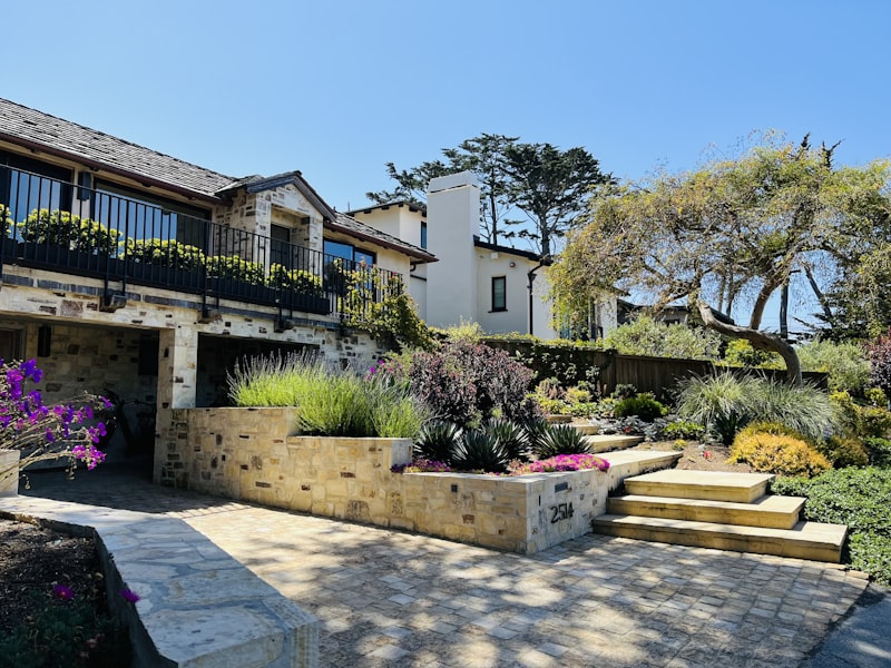 Beautiful house with stunning landscaping under a blue sky.