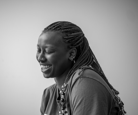 A smiling woman with braided hair.