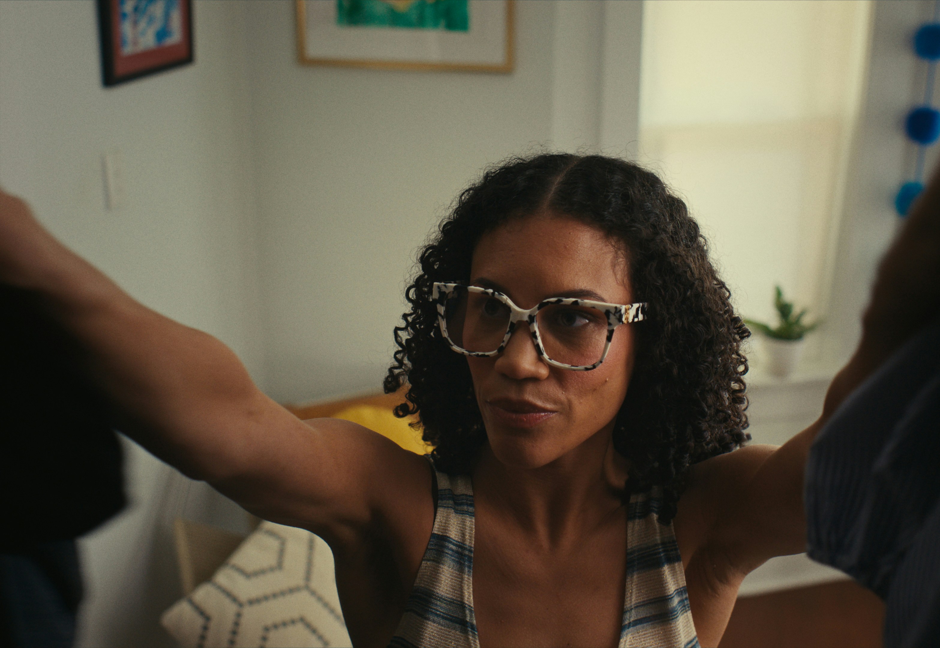 Woman with arms up and cool glasses.