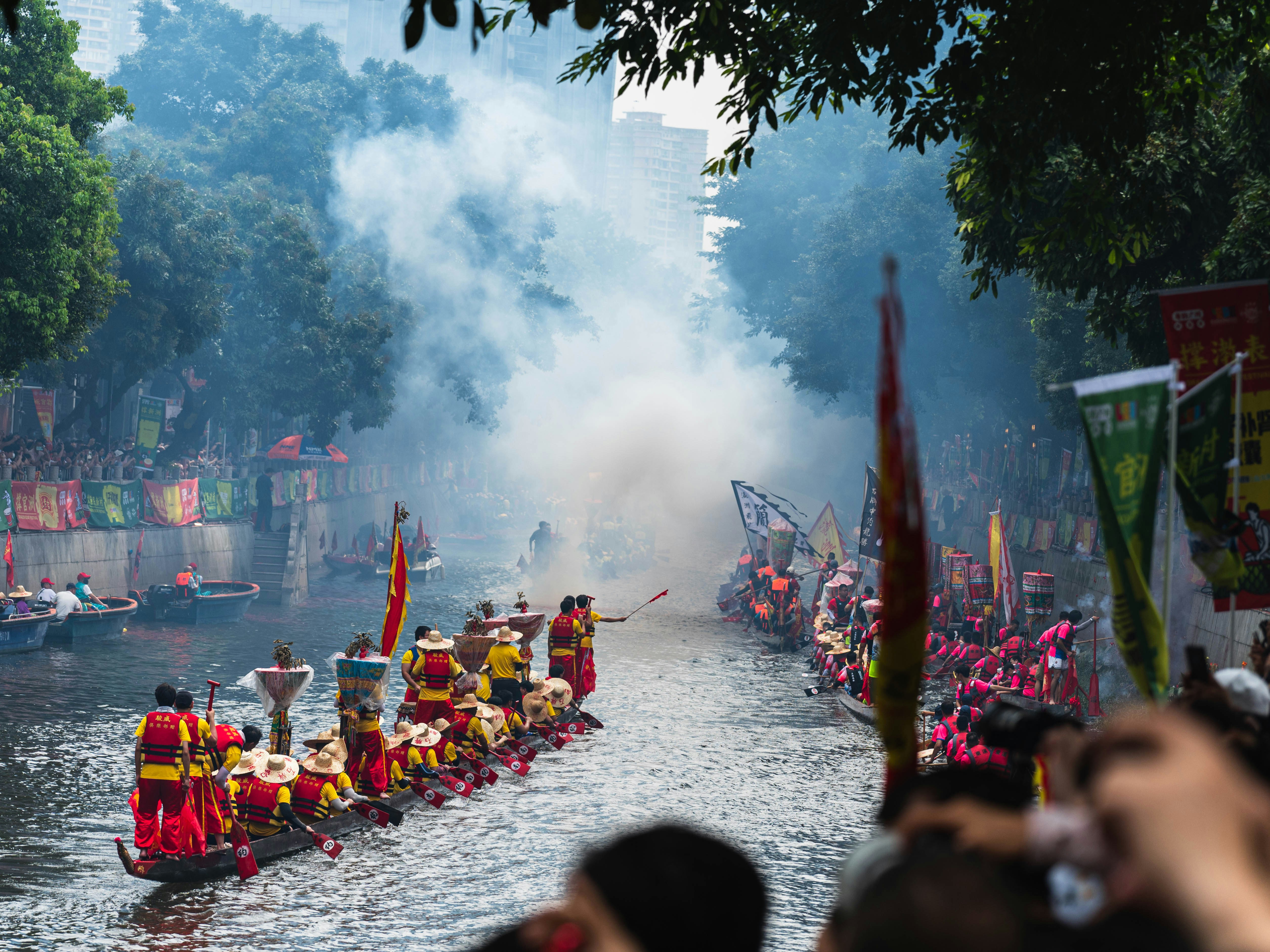 Dragon boats race down the river in a festival.