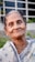 An older woman smiles at the camera.