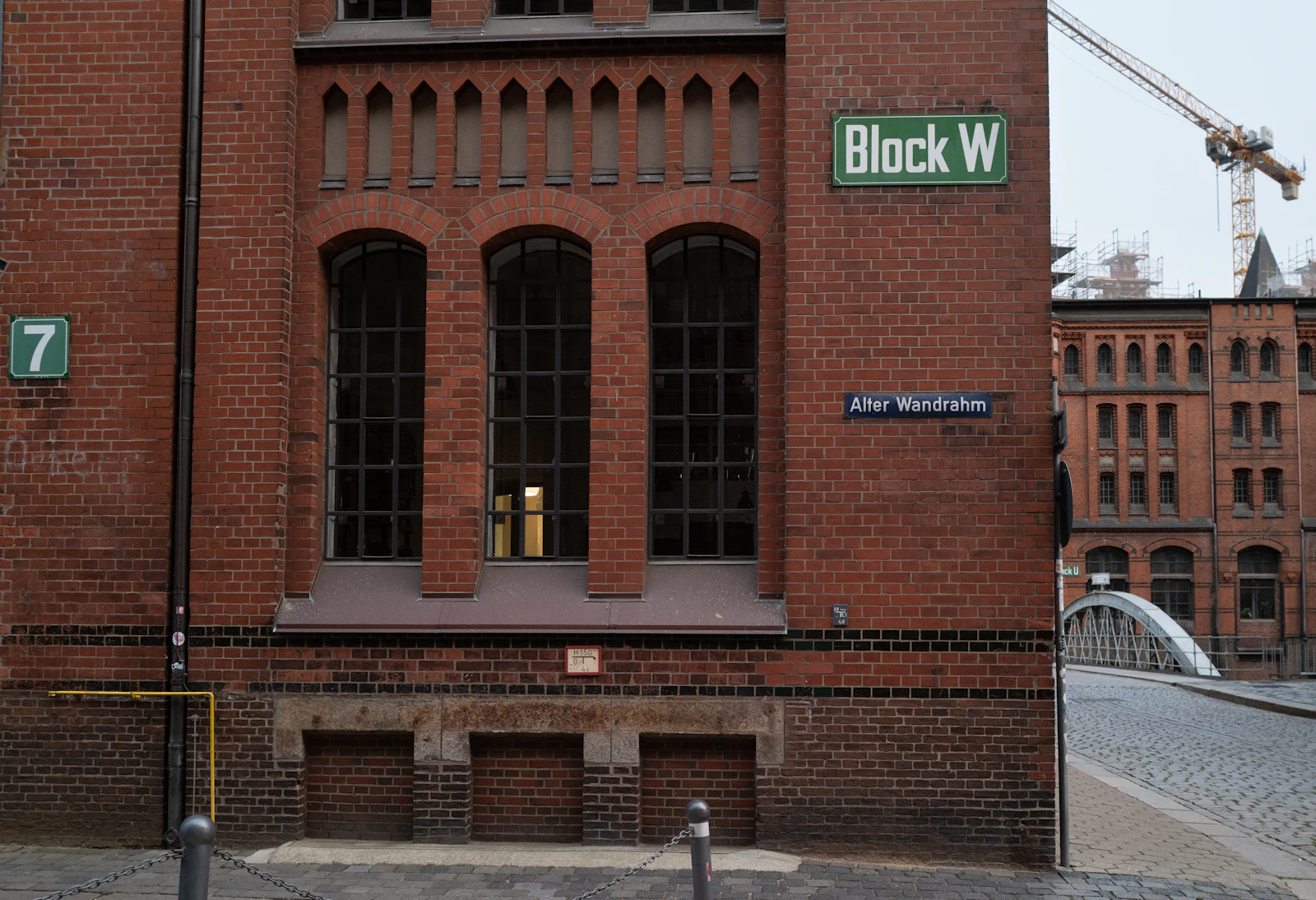 Backsteingebäude mit großen Fenstern und Schild in der Hamburger Speicherstadt