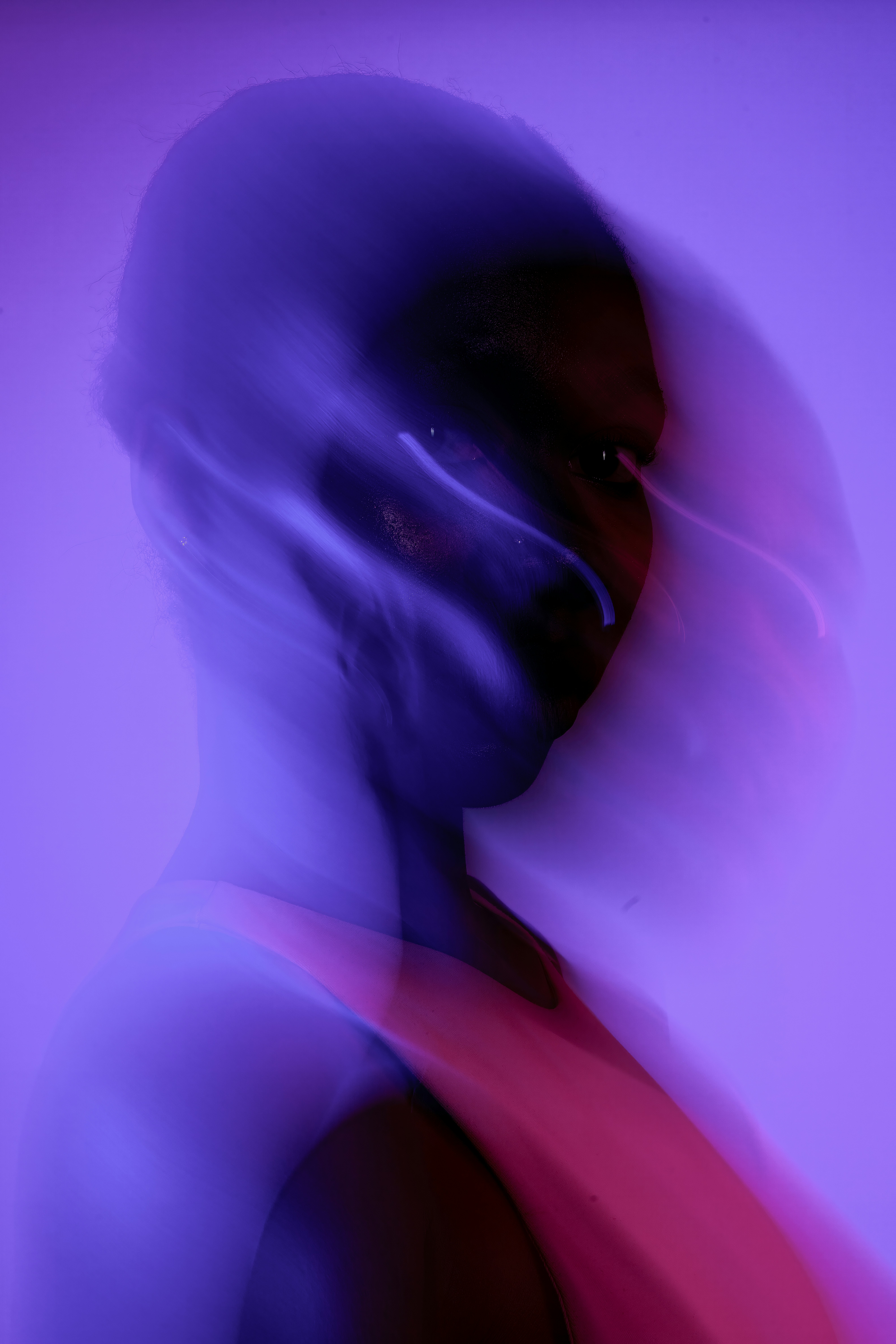 A blurred portrait in vibrant purple and pink.