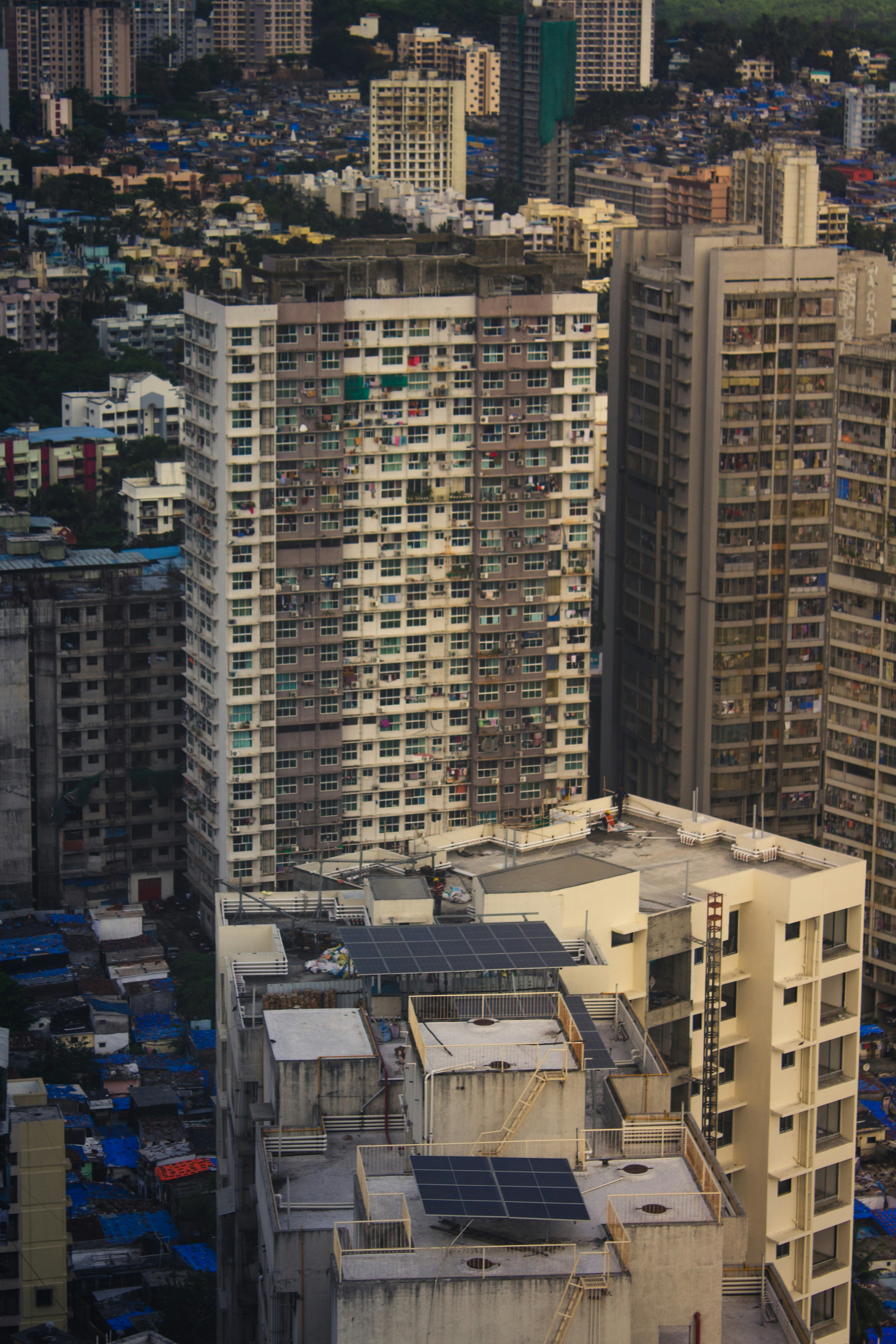 High-rise buildings stand tall in a crowded city. photo – Free Building ...