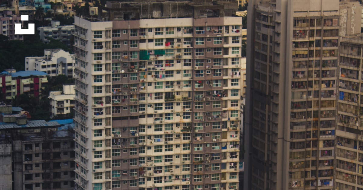 High-rise buildings stand tall in a crowded city. photo – Free Building ...