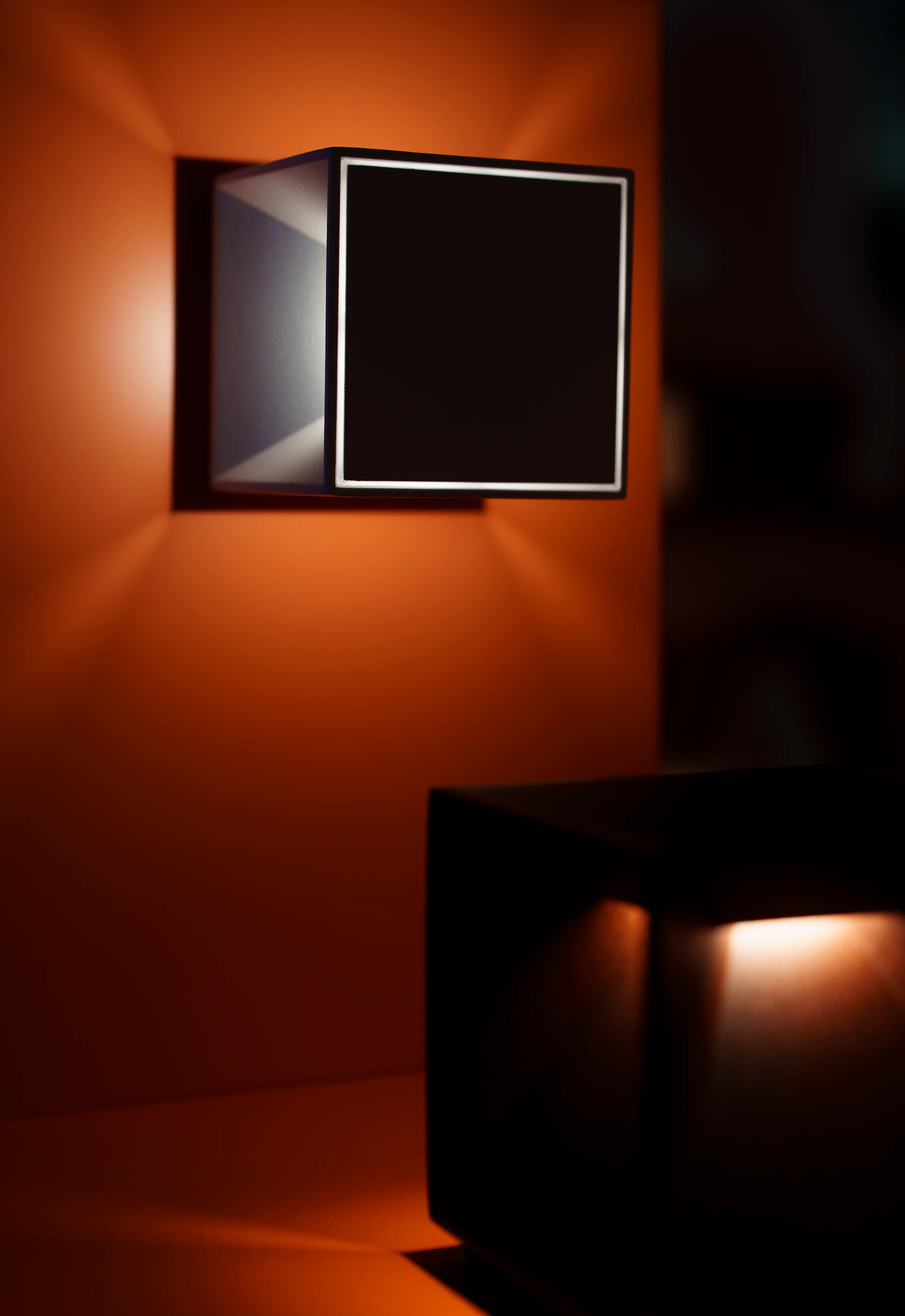 Modern cube-shaped lights illuminate a dark, orange space.