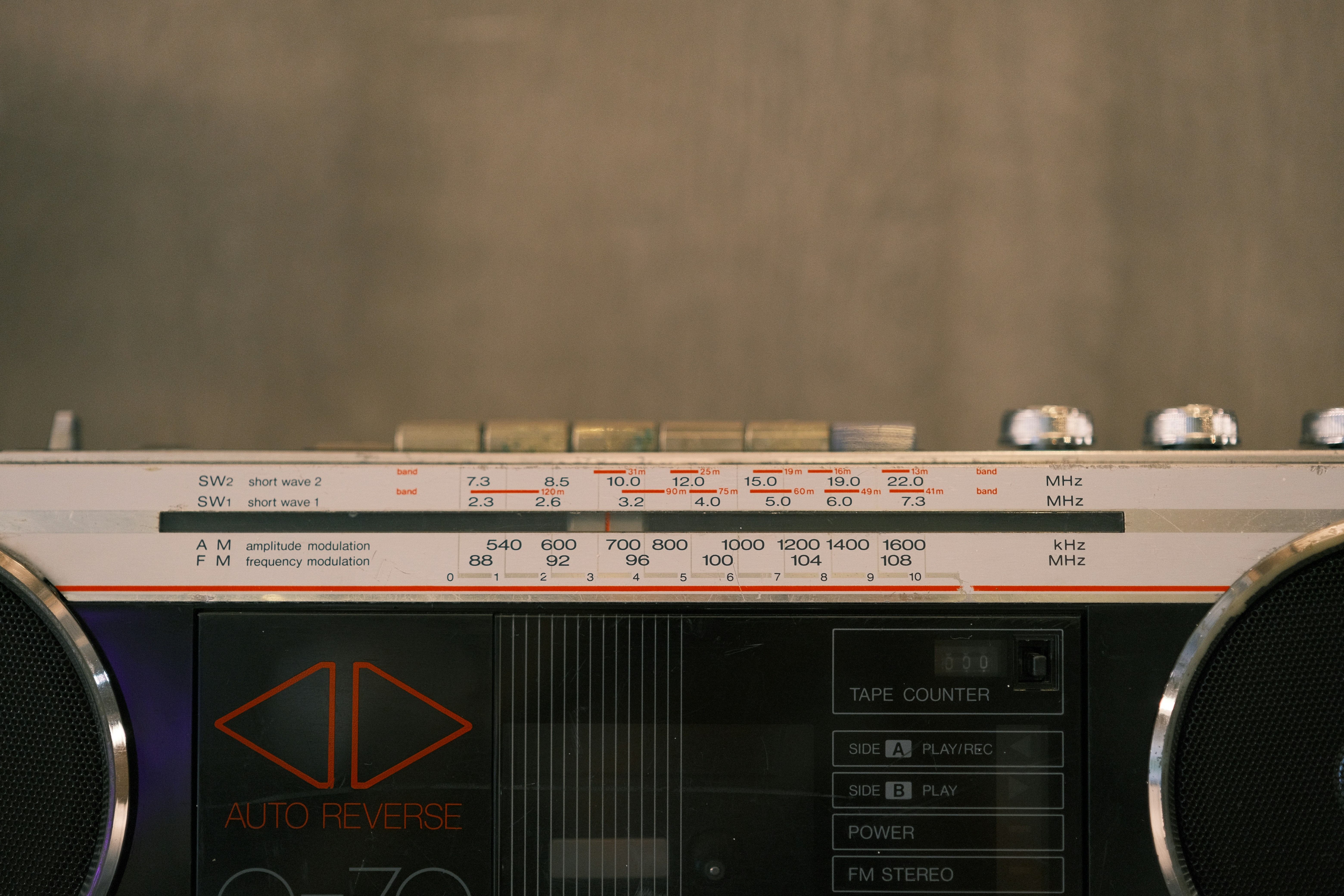 Here is a sentence: a vintage boombox is displayed in the picture