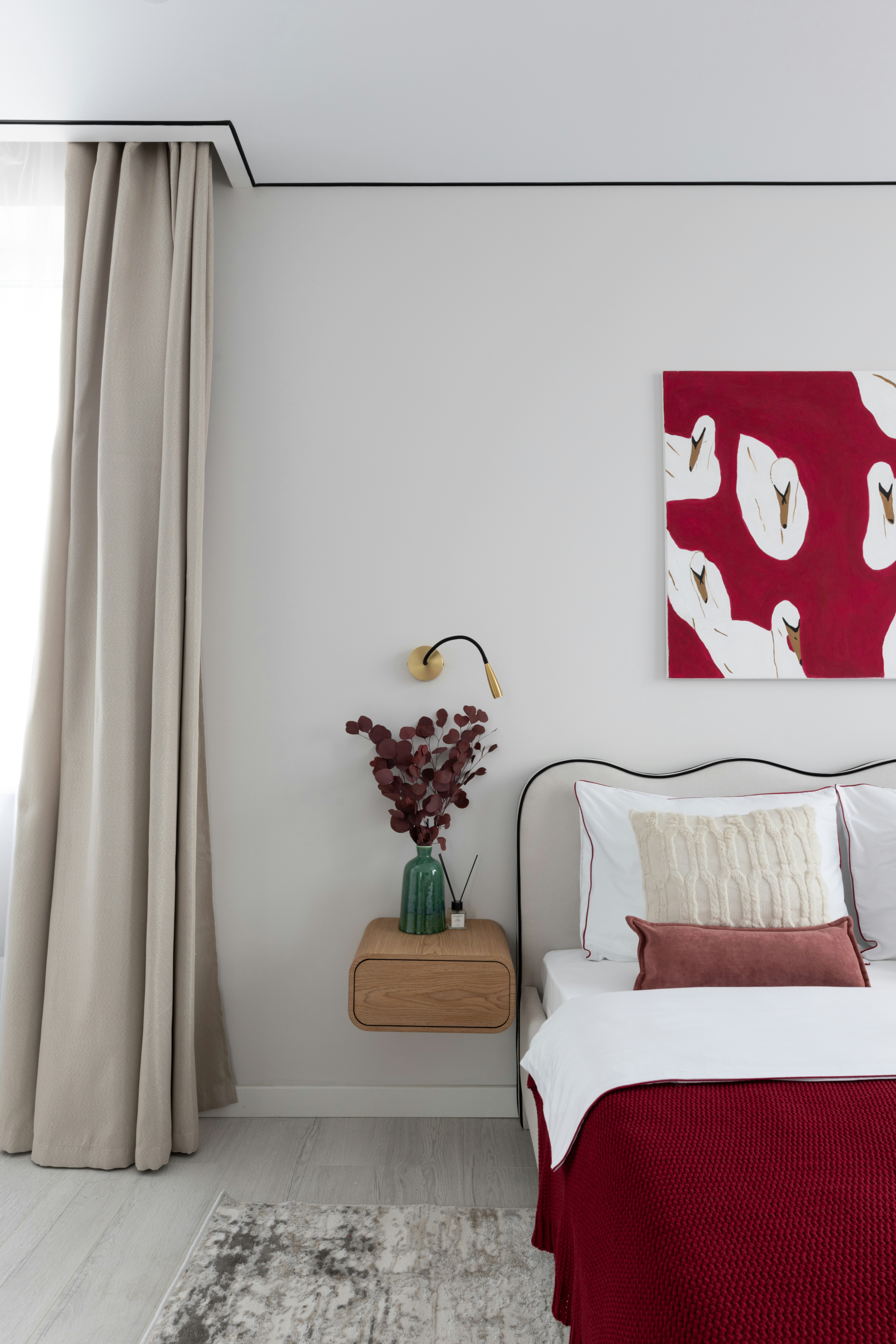 A cozy bedroom features art and elegant decor.