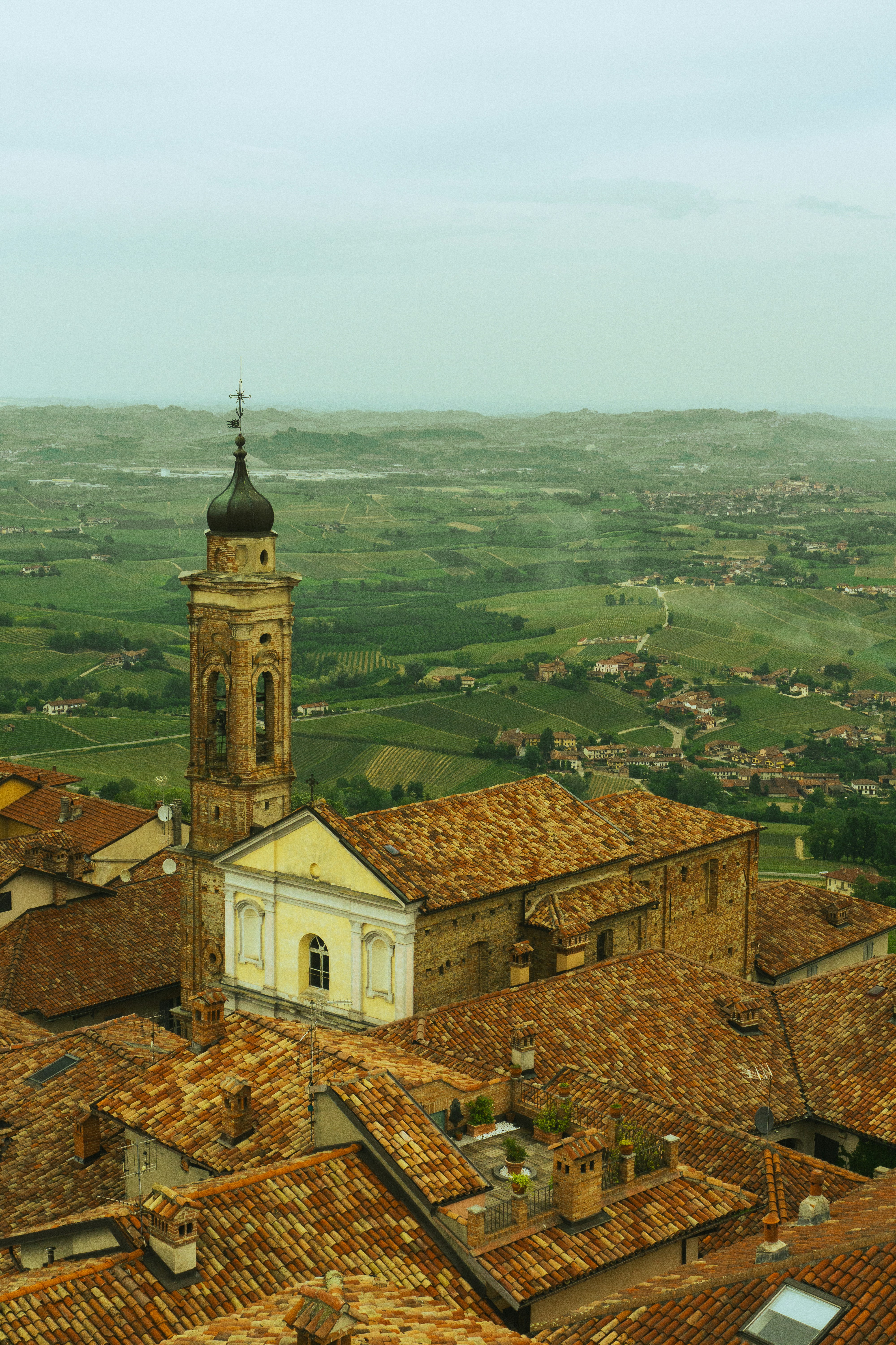 Church overlooking a scenic green landscape.