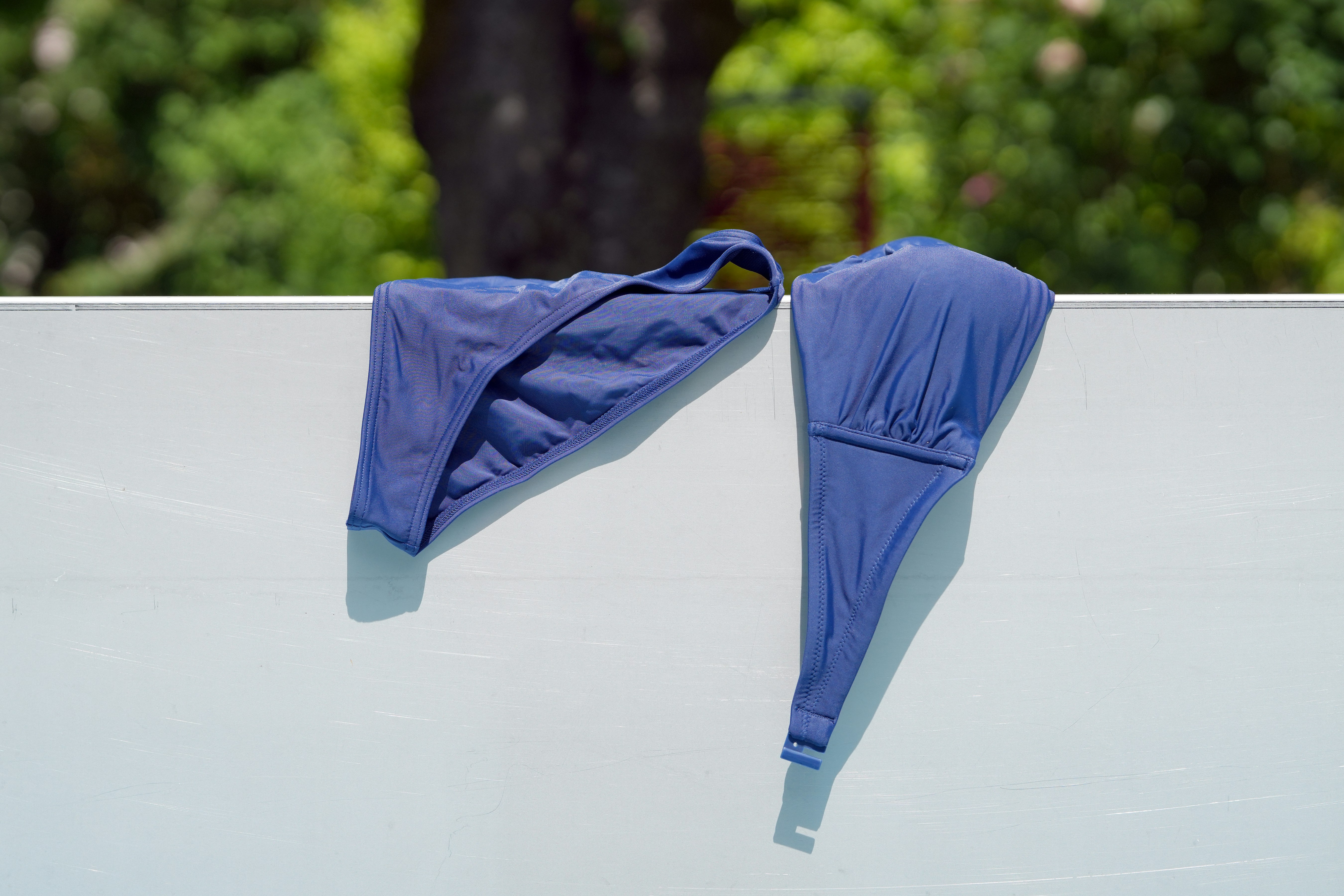 Blue bikini on white surface