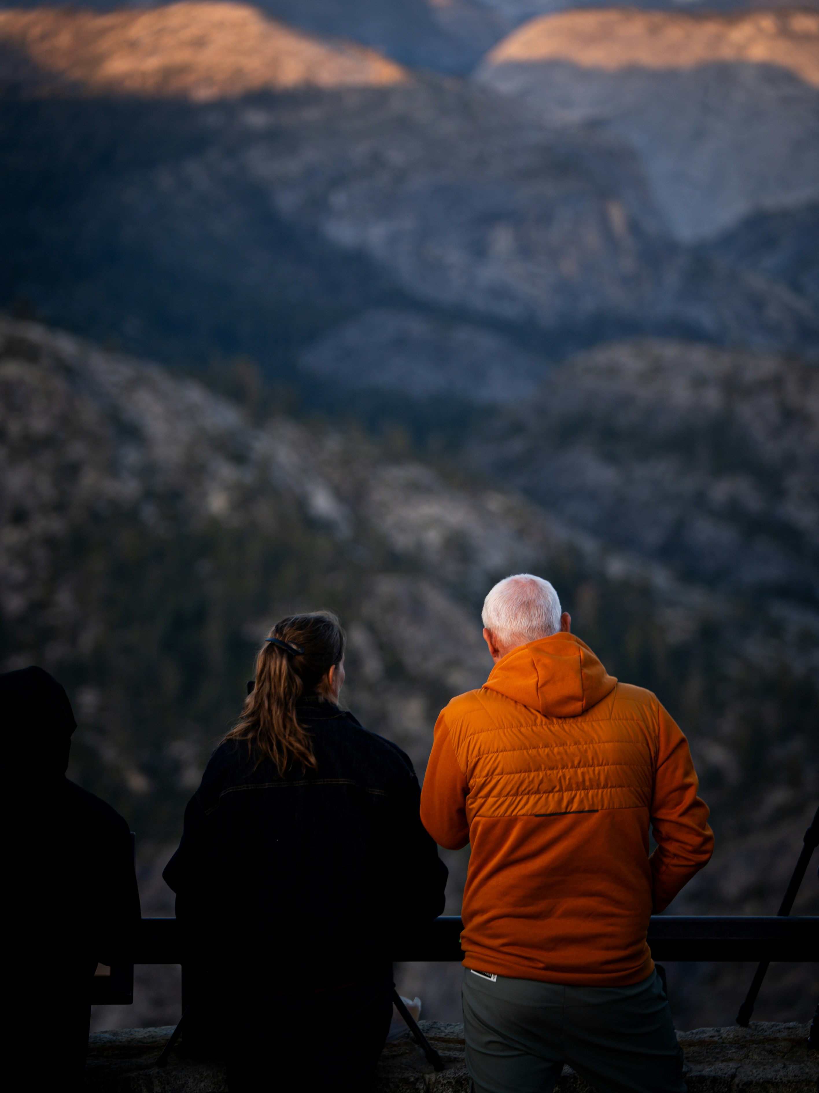People admire the mountain view at sunset.