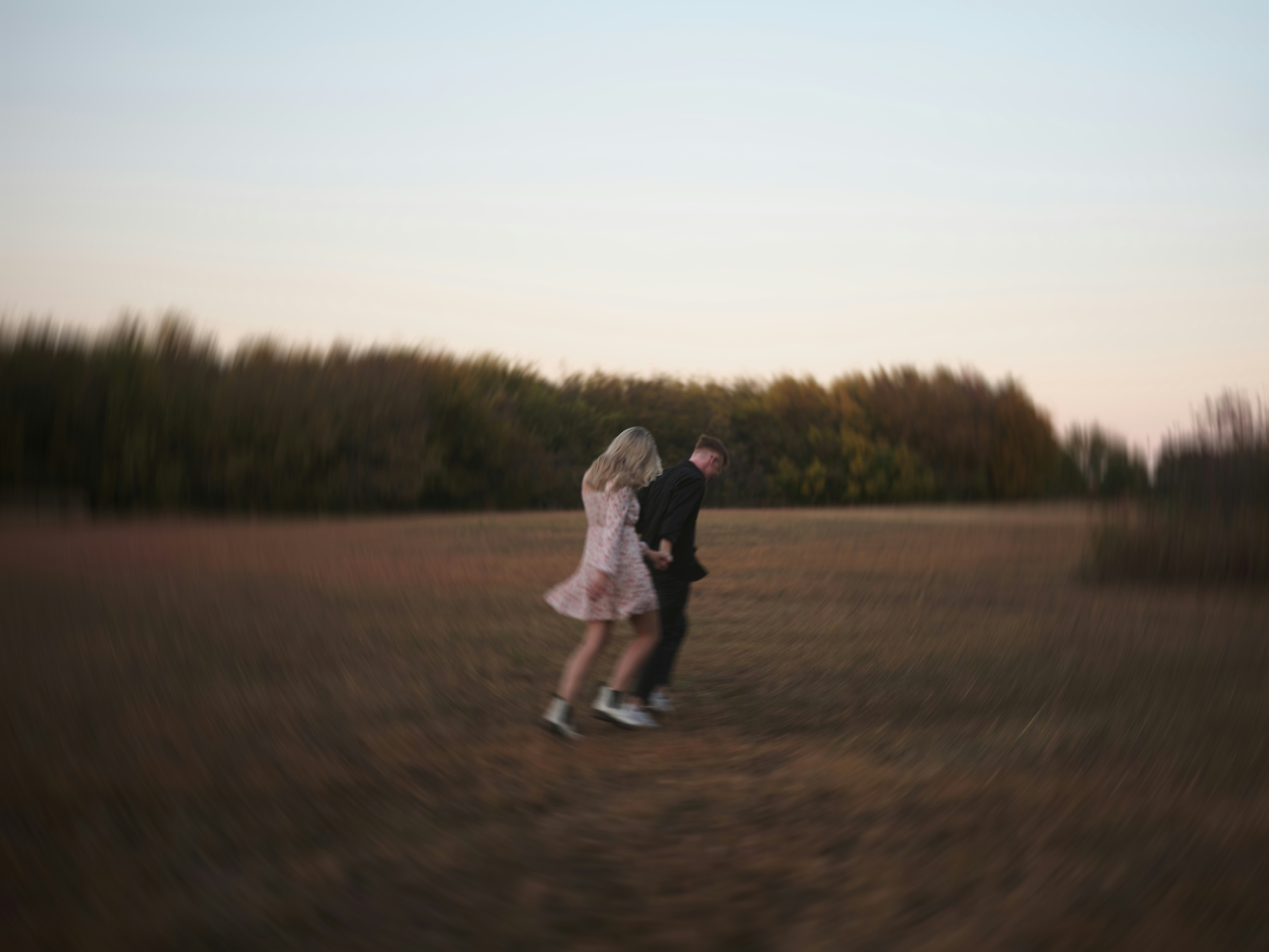Romantic couple running in field
