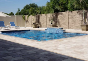 A luxurious pool area with a water feature