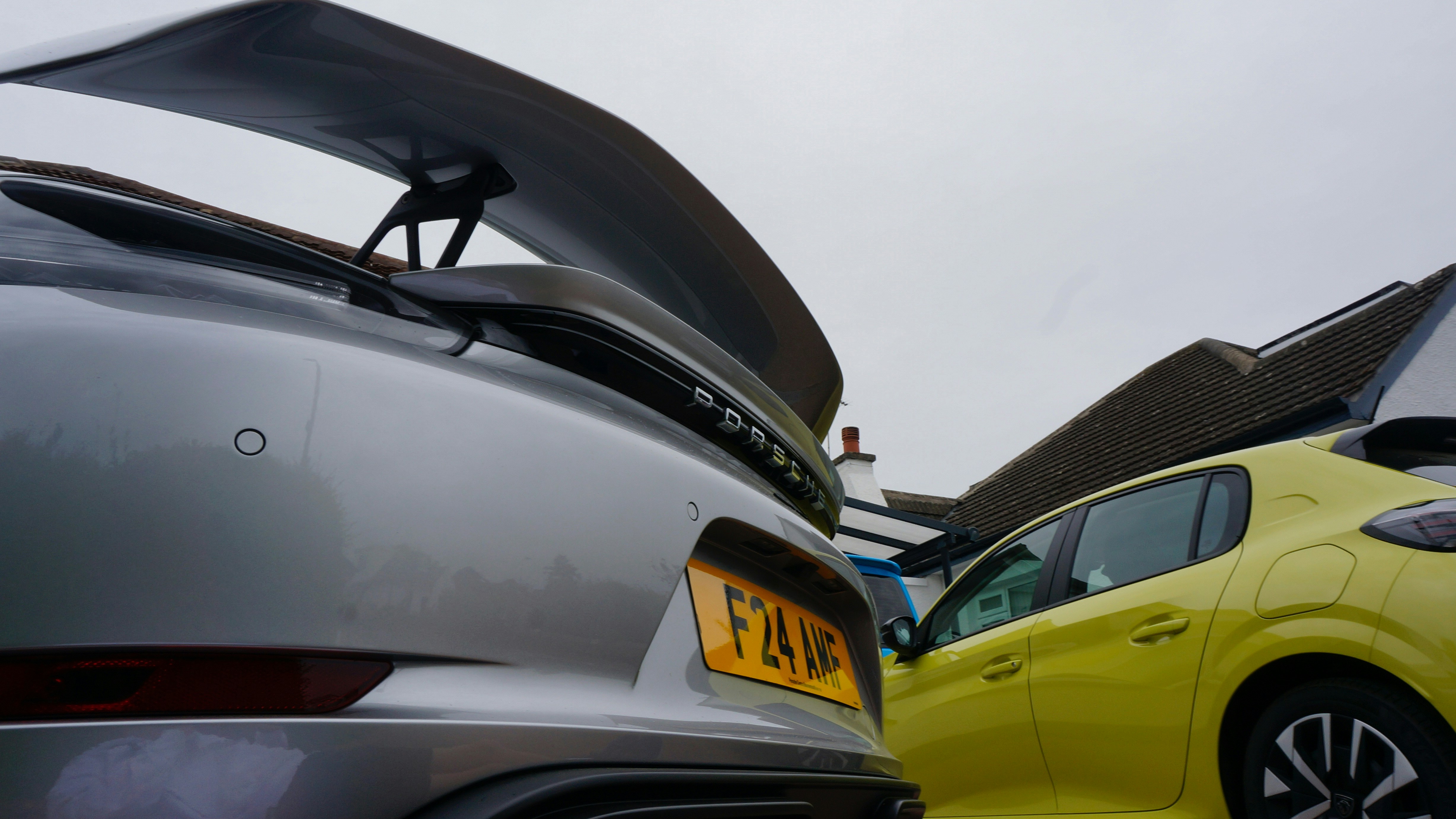 A silver sports car and a yellow hatchback.