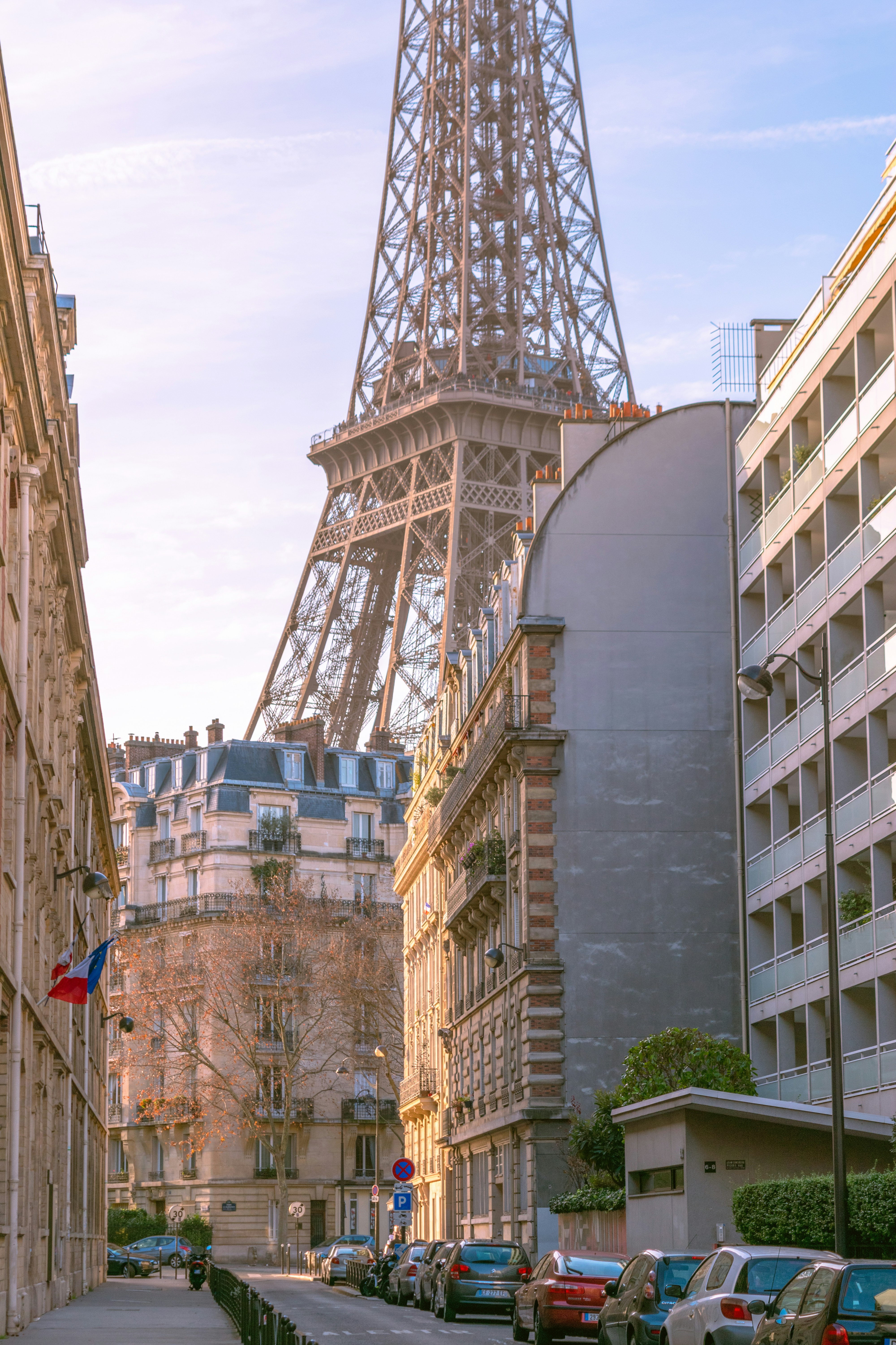 Eiffel tower looms over parisian buildings.