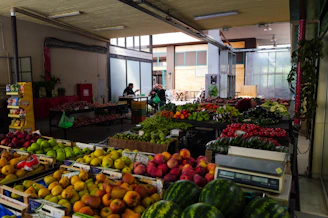 Produce is displayed at an indoor market.