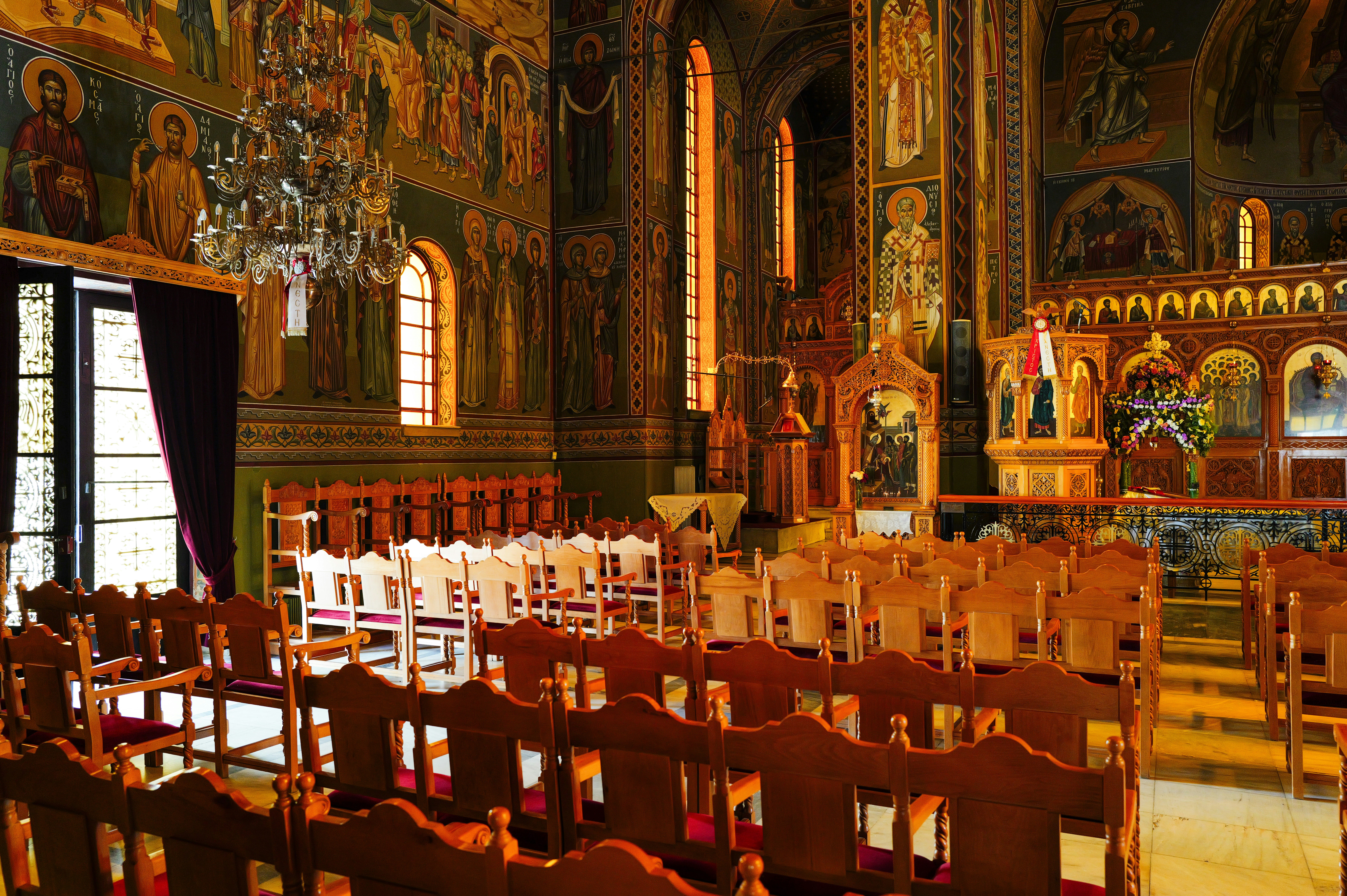 Inside of an ornate church with rows of chairs. (Photo by Adrien Olichon on Unsplash)