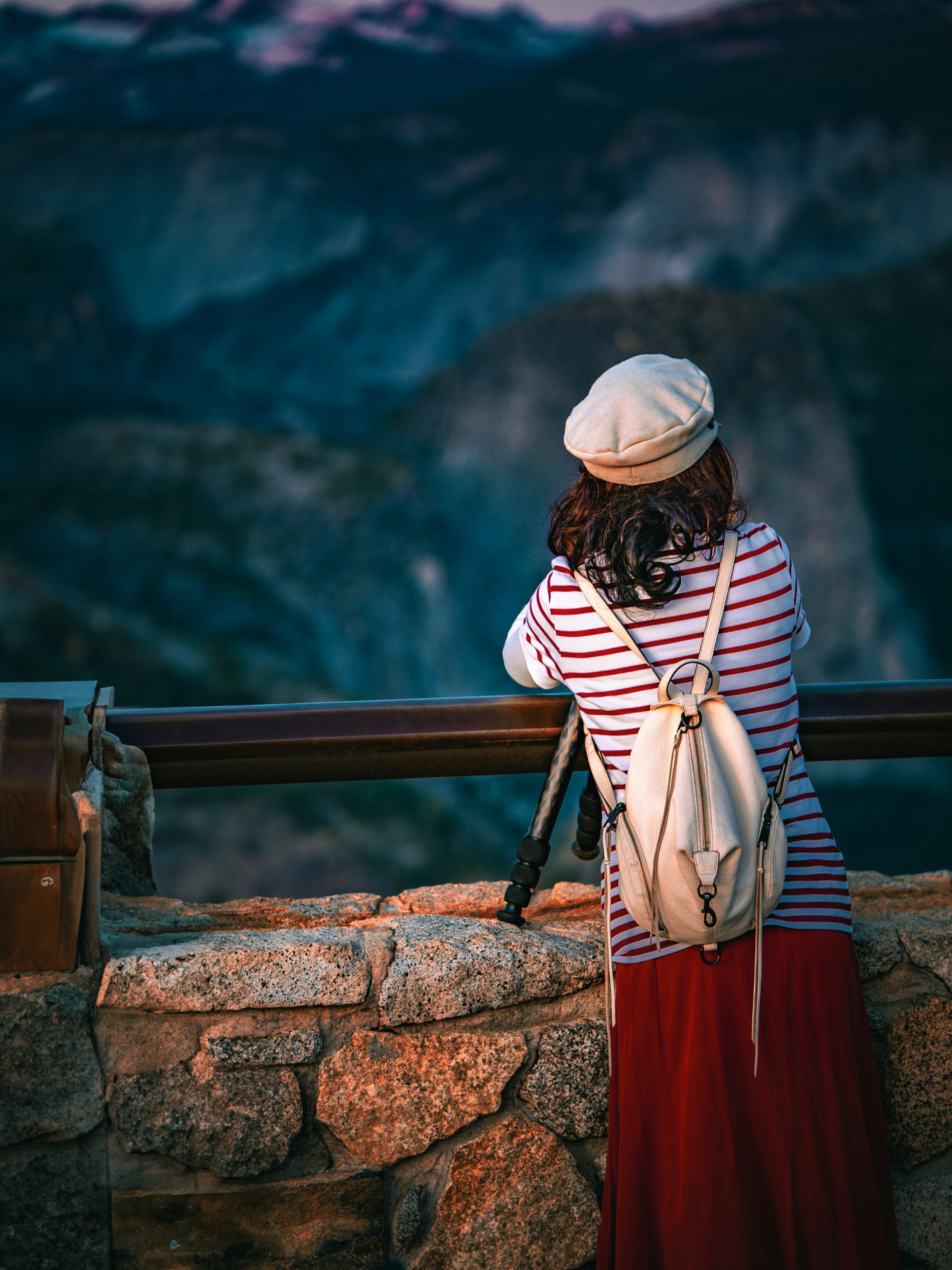 Woman gazes at a mountain vista in the distance.