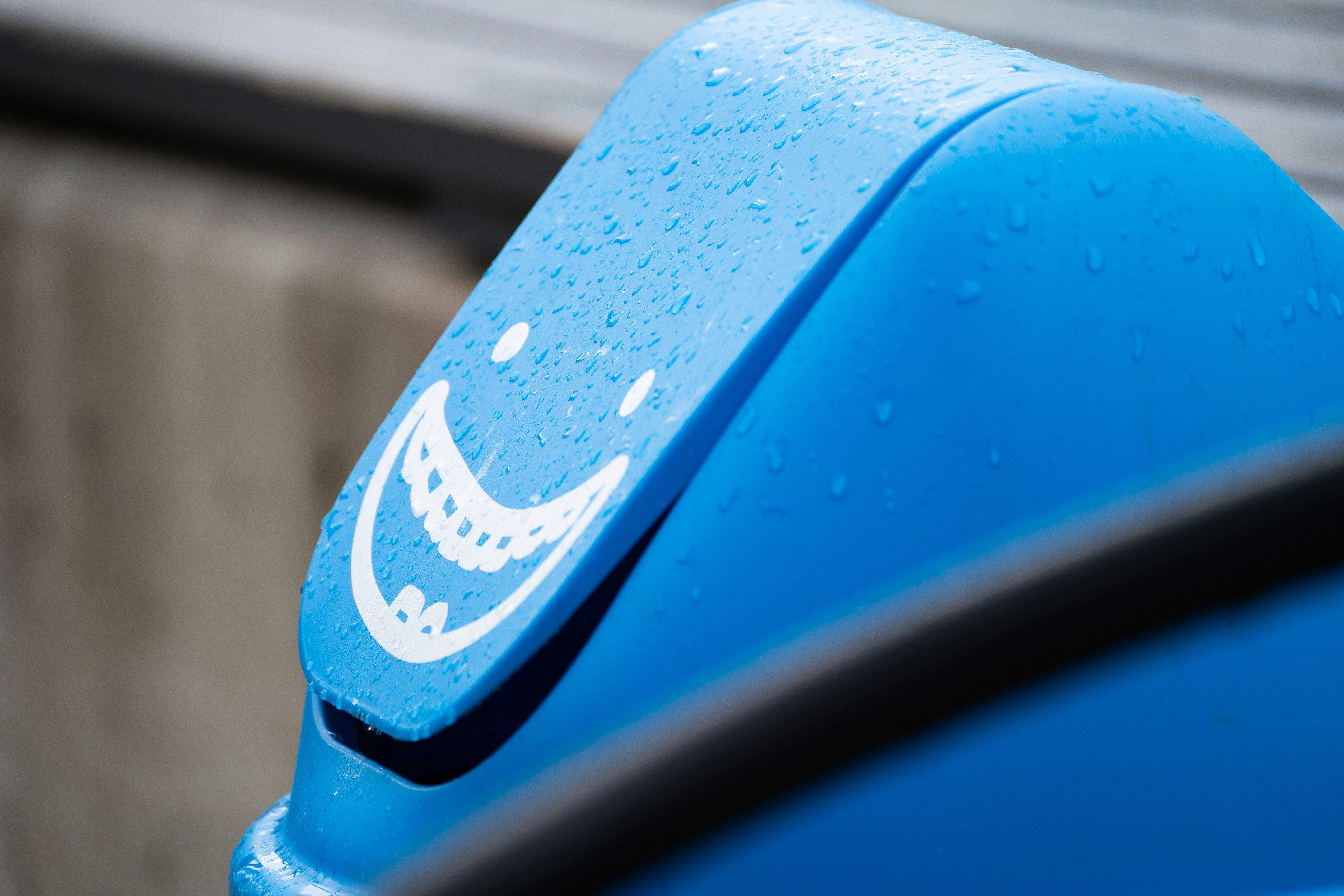Blue trash can with happy face