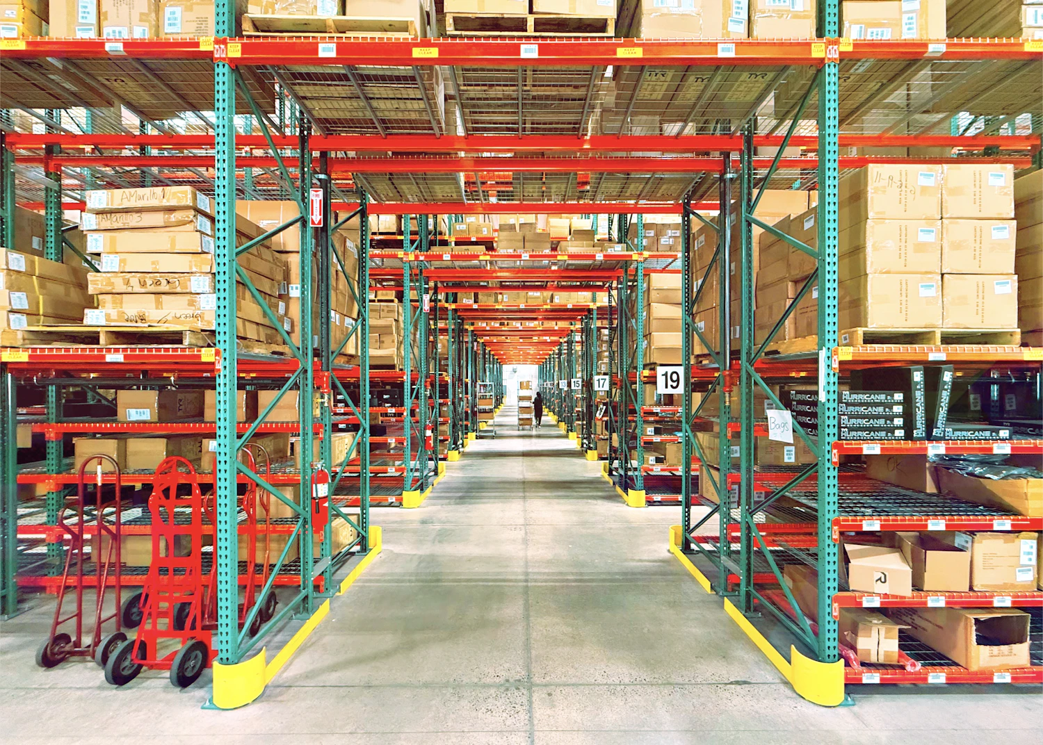 A warehouse aisle lined with stocked shelves of inventory