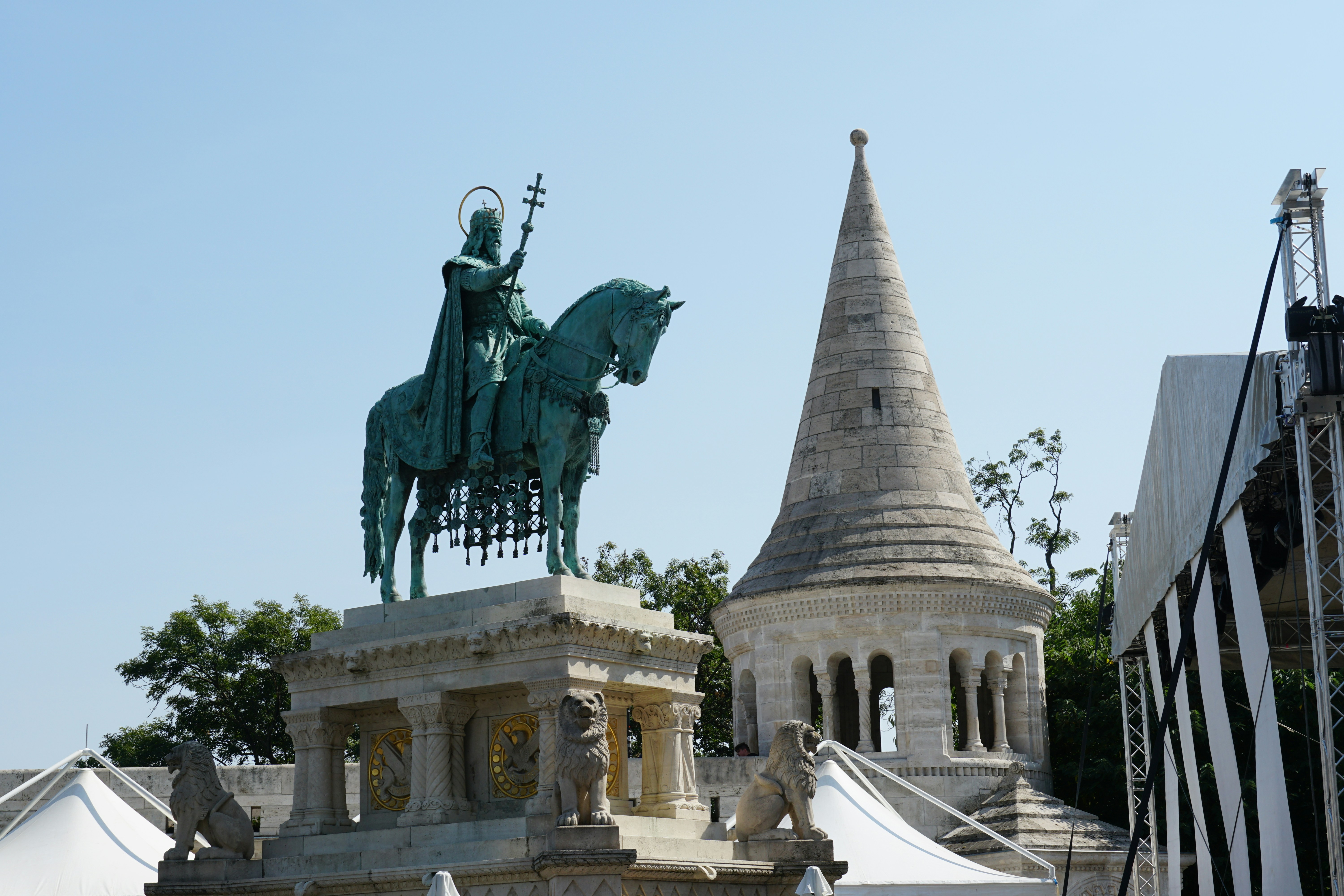 A statue of a rider and a church tower.