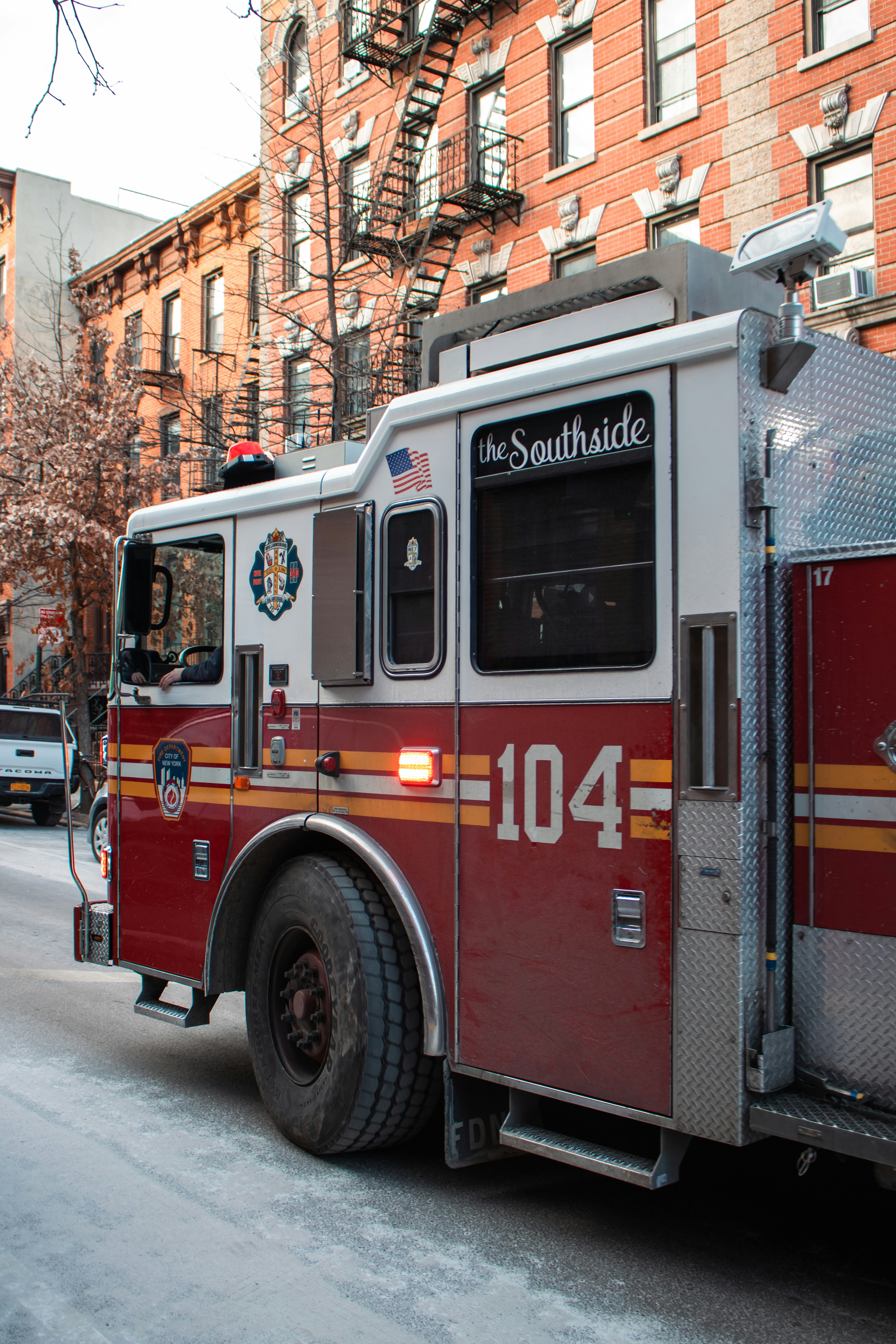 A fire truck drives on a city street