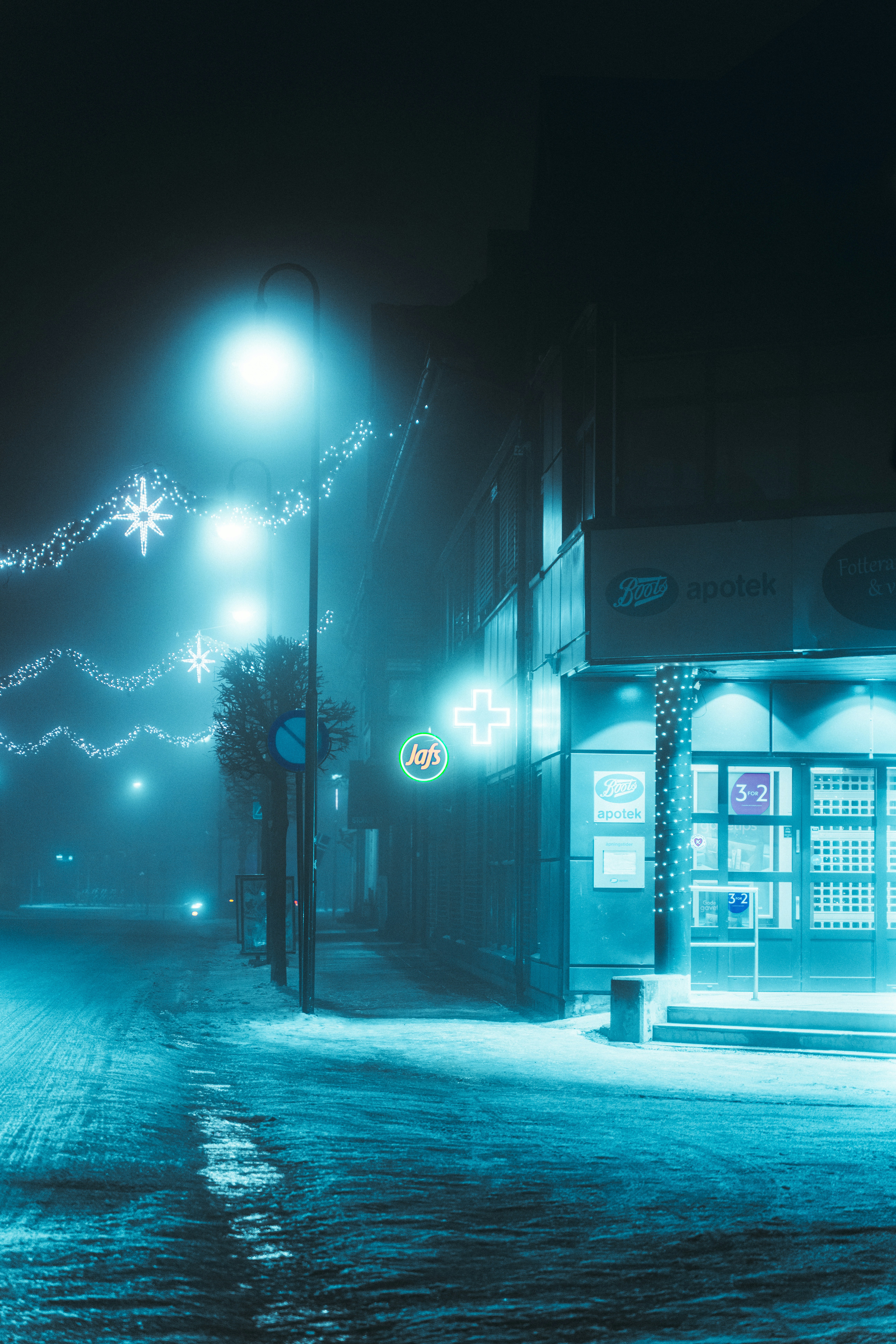 A pharmacy at night in a winter landscape.