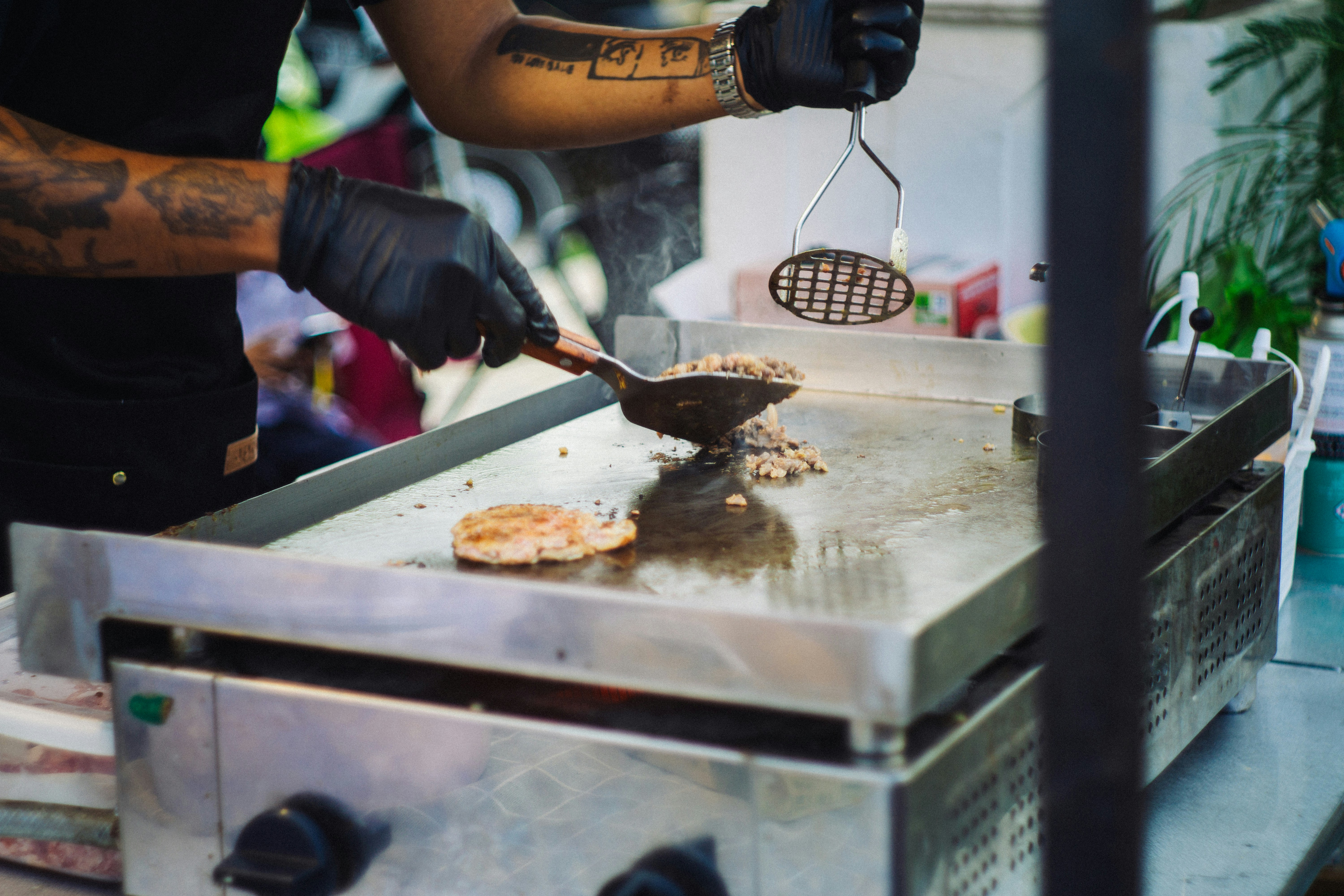 A chef cooks food on a griddle.