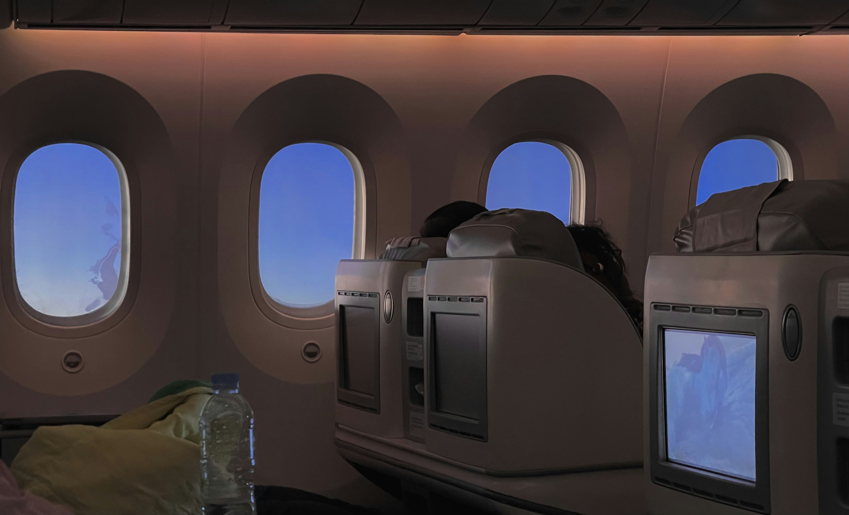 Inside of a passenger plane with blue sky., Business class on the way to South Korea