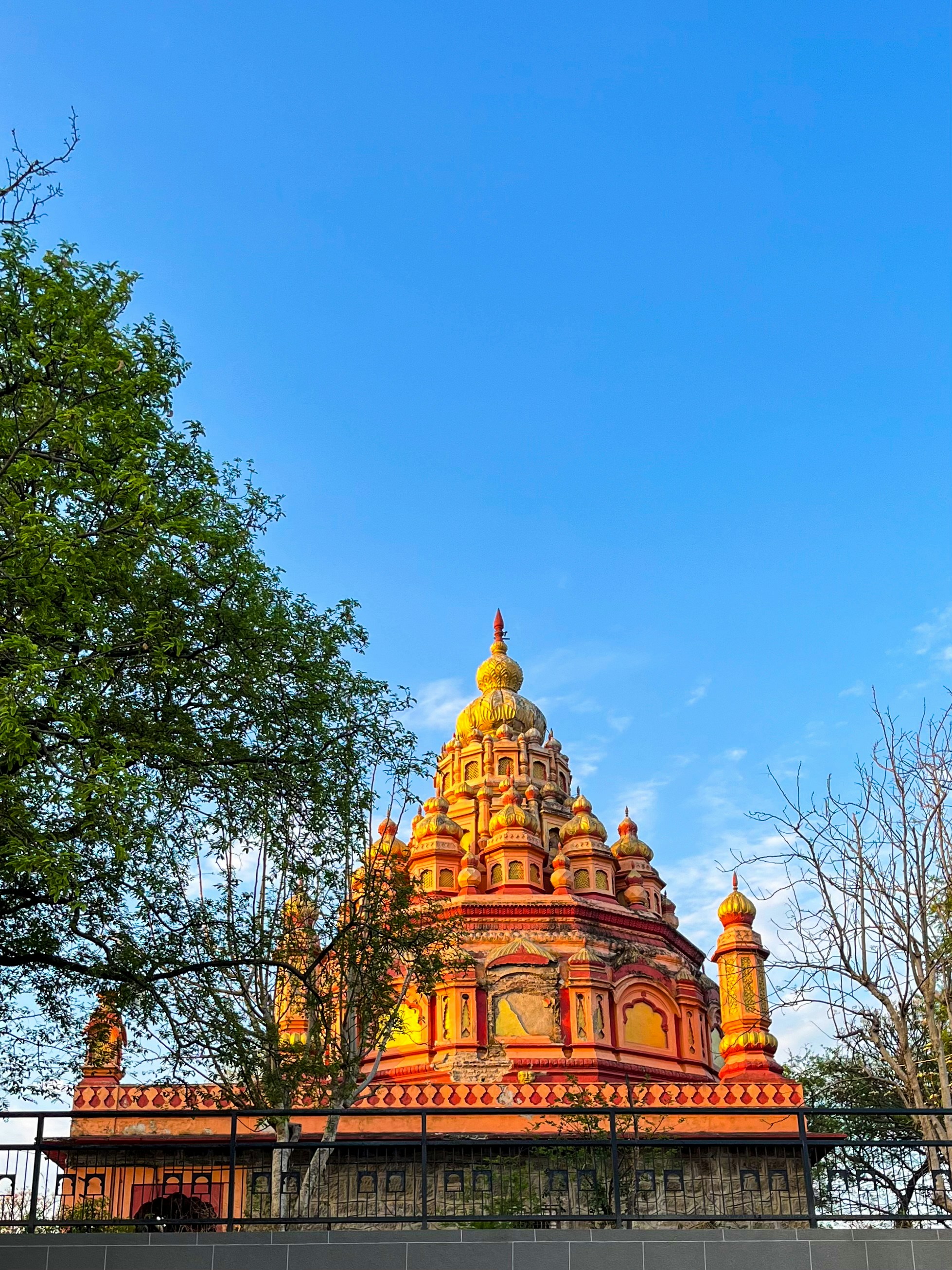 A colorful temple rises against a bright blue sky. photo – Free ...