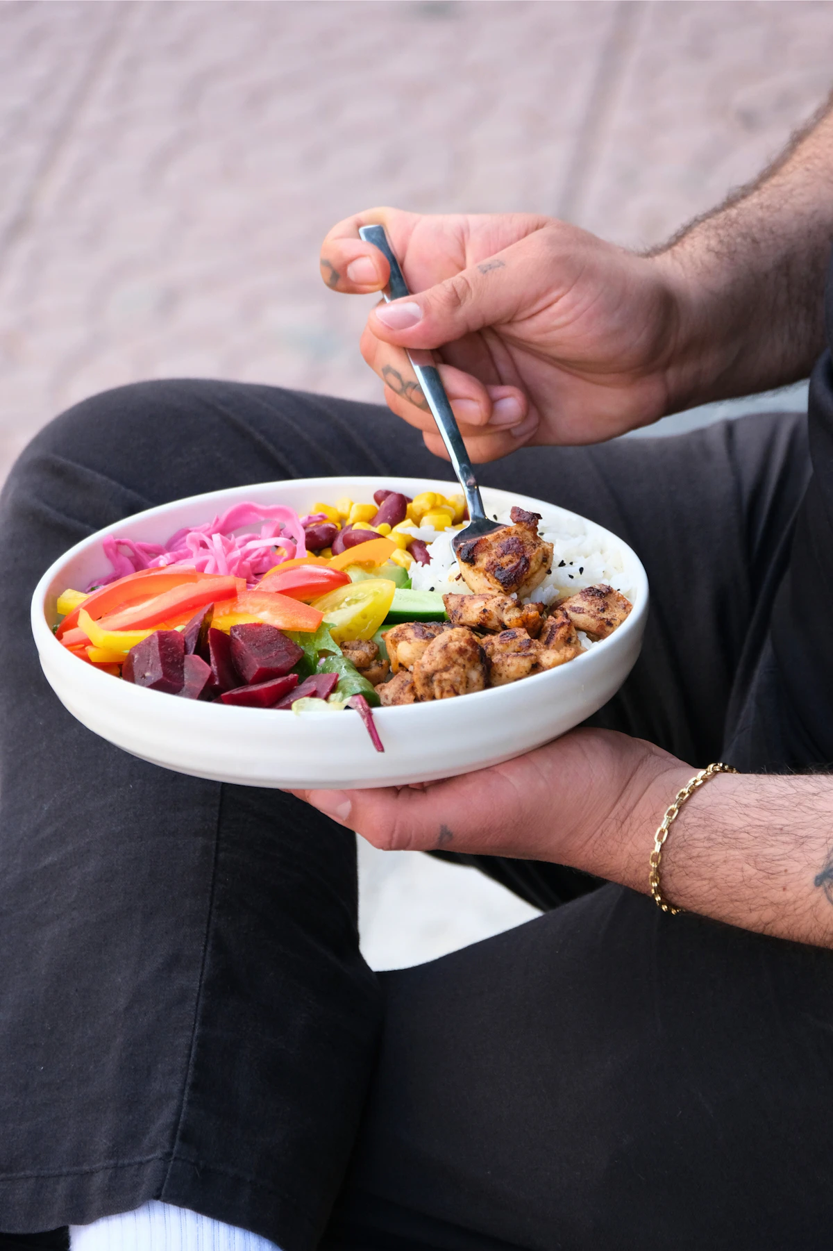 Man holding a grilled chicken and vegetable bowl outdoors, illustrating diet changes that support erectile function.