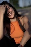 A smiling woman is enjoying the sunshine.