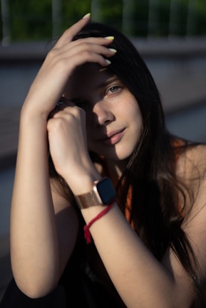 A young woman poses, smiling.